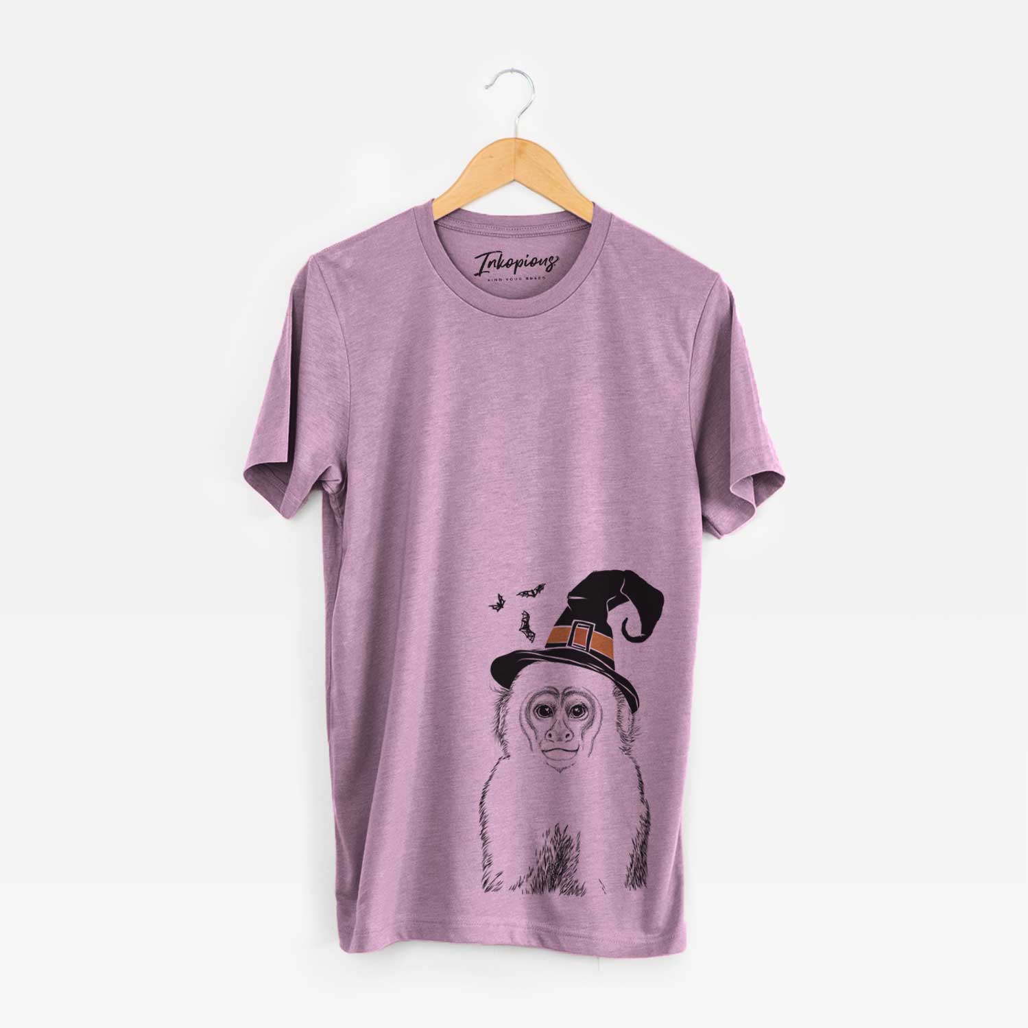 Hand-drawn sketch of Marcel the Capuchin Monkey wearing a witch hat on an Orchid Unisex crewneck