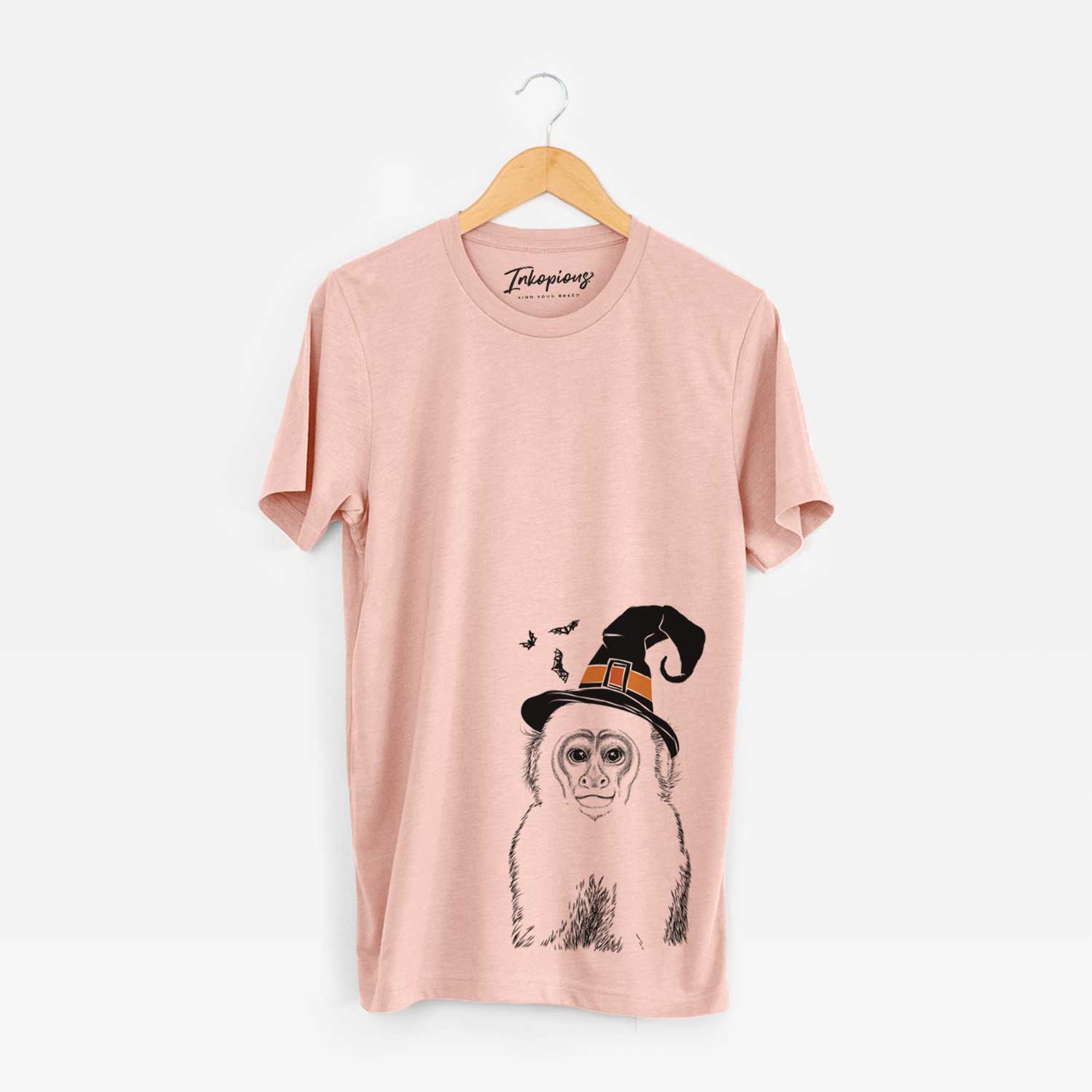 Hand-drawn sketch of Marcel the Capuchin Monkey wearing a witch hat on a Peach Unisex crewneck