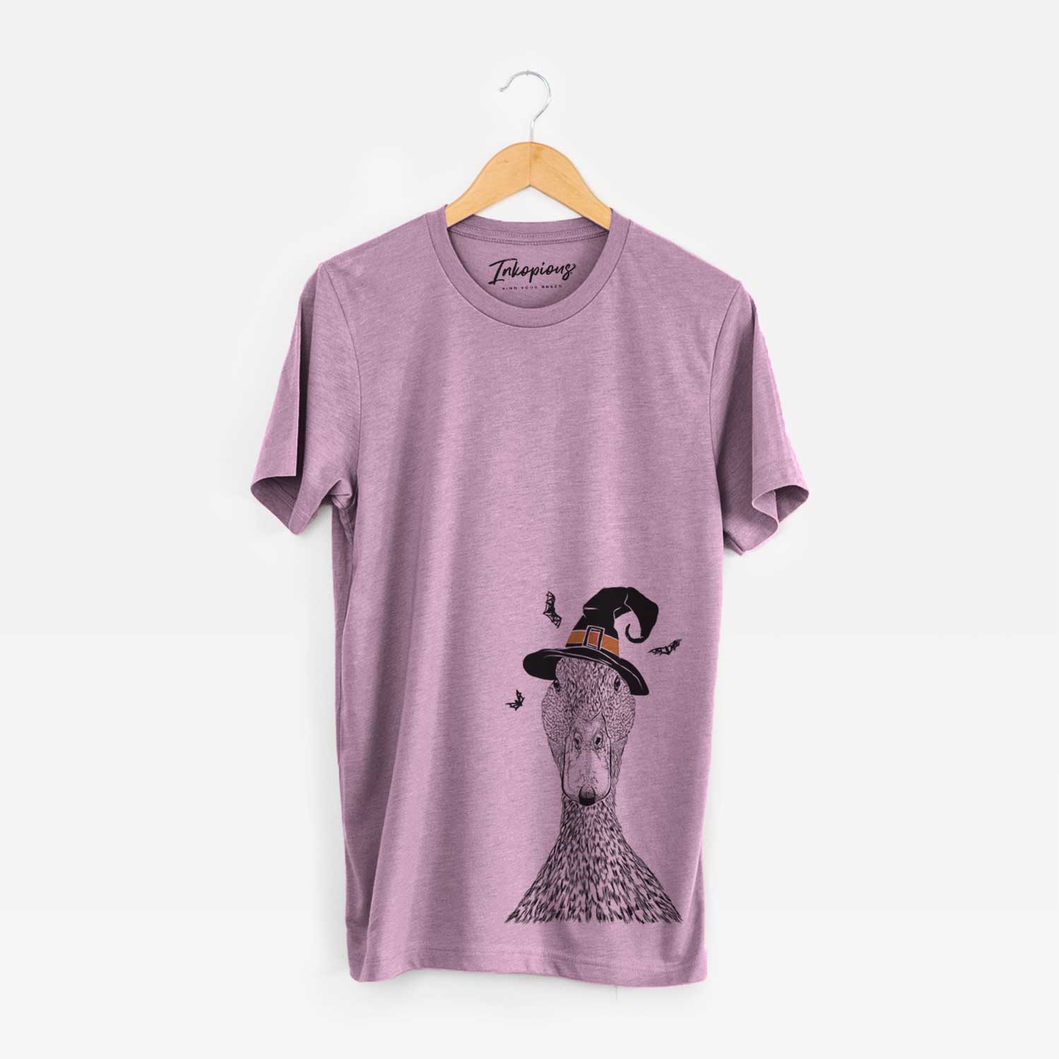 Hand-drawn sketch of Marge the Mallard Duck wearing a witch hat on an Orchid Unisex crewneck