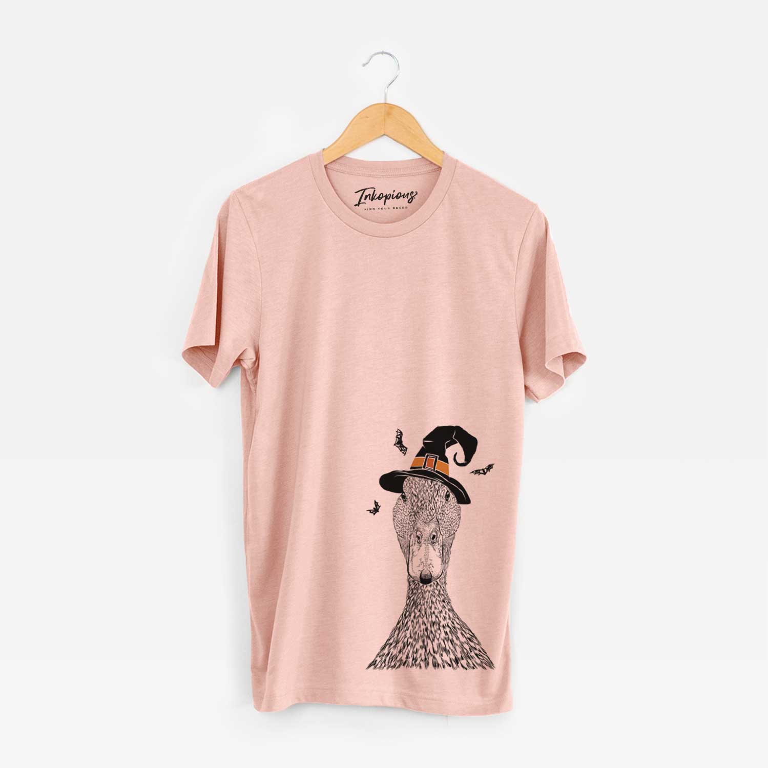 Hand-drawn sketch of Marge the Mallard Duck wearing a witch hat on a Peach Unisex crewneck