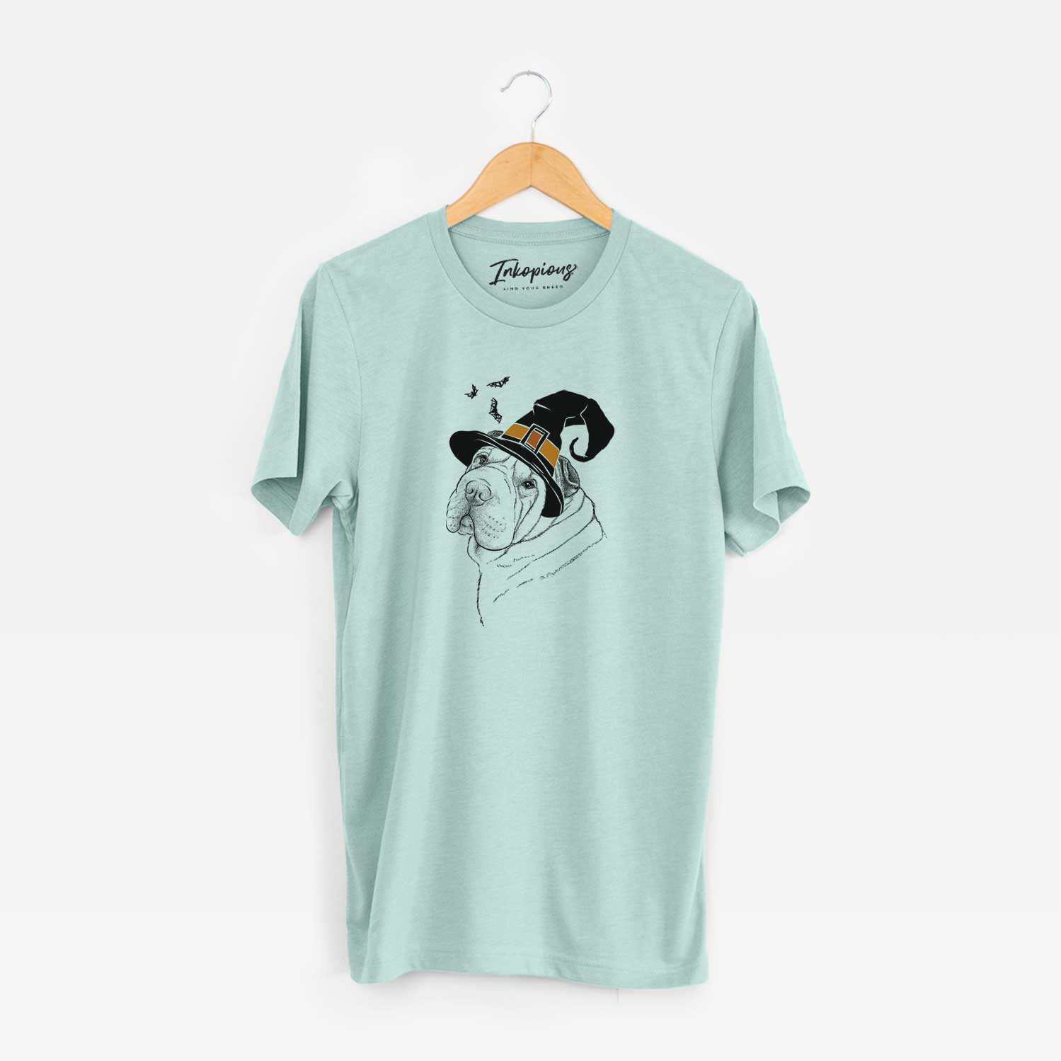 Hand-drawn sketch of Maximus the Shar Pei wearing a witch hat on a Heather Sage Unisex crewneck