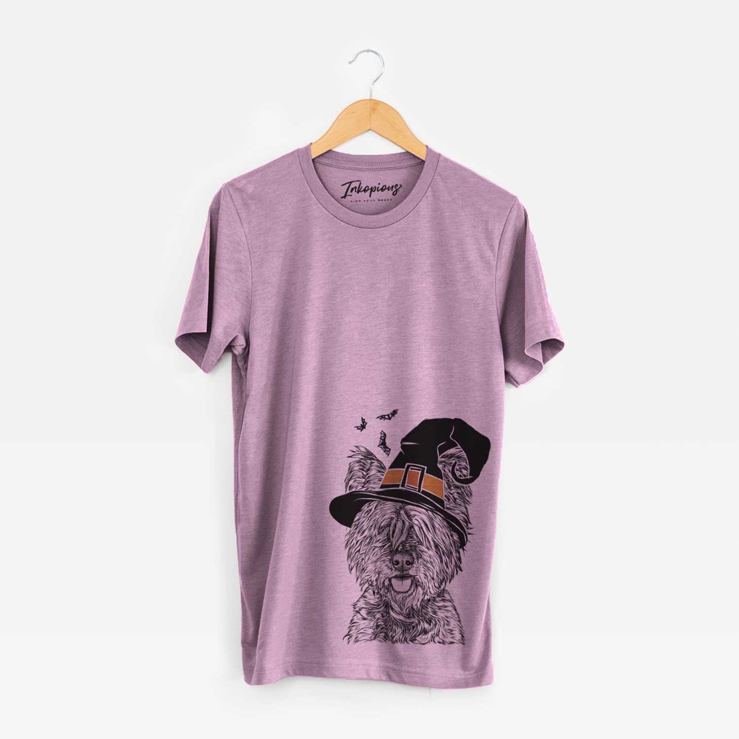 Hand-drawn sketch of McDuff the Cairn Terrier wearing a witch hat on an Orchid Unisex crewneck