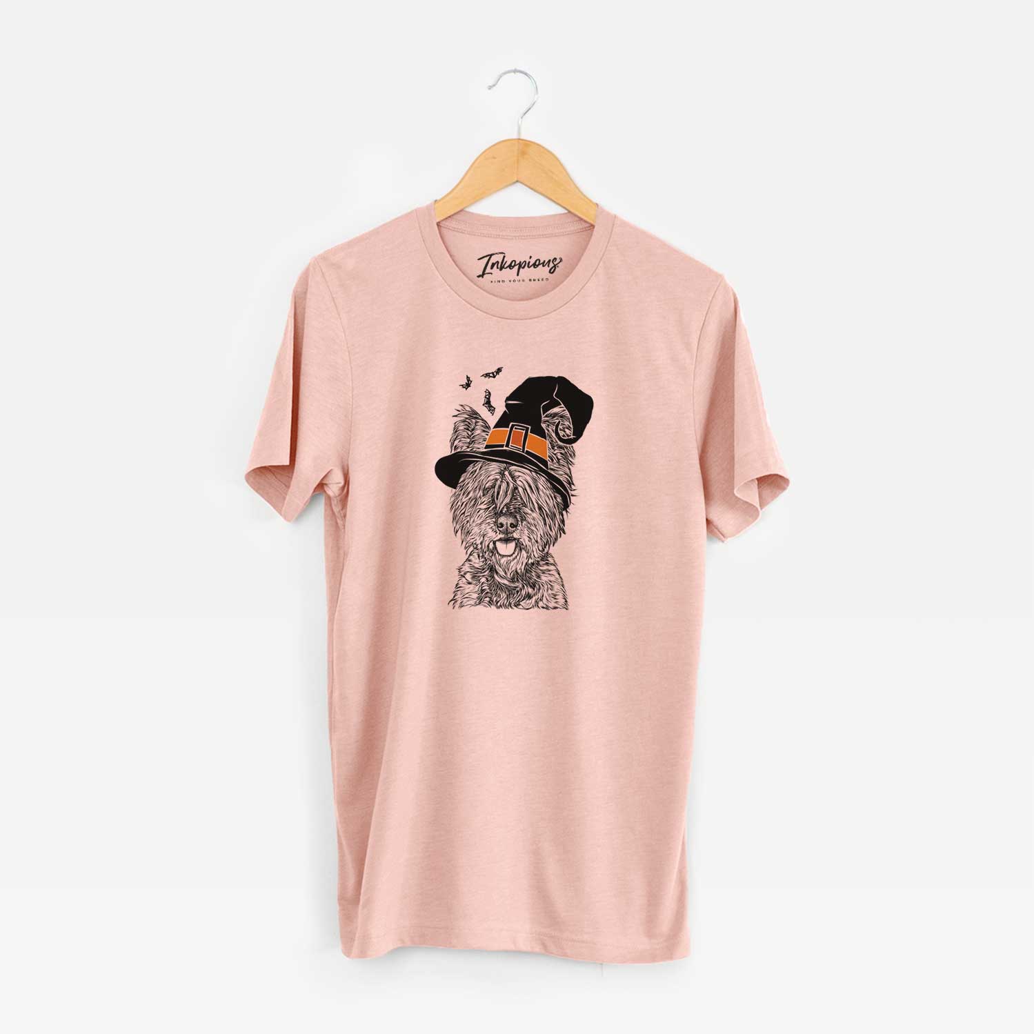 Hand-drawn sketch of McDuff the Cairn Terrier wearing a witch hat on a Peach Unisex crewneck