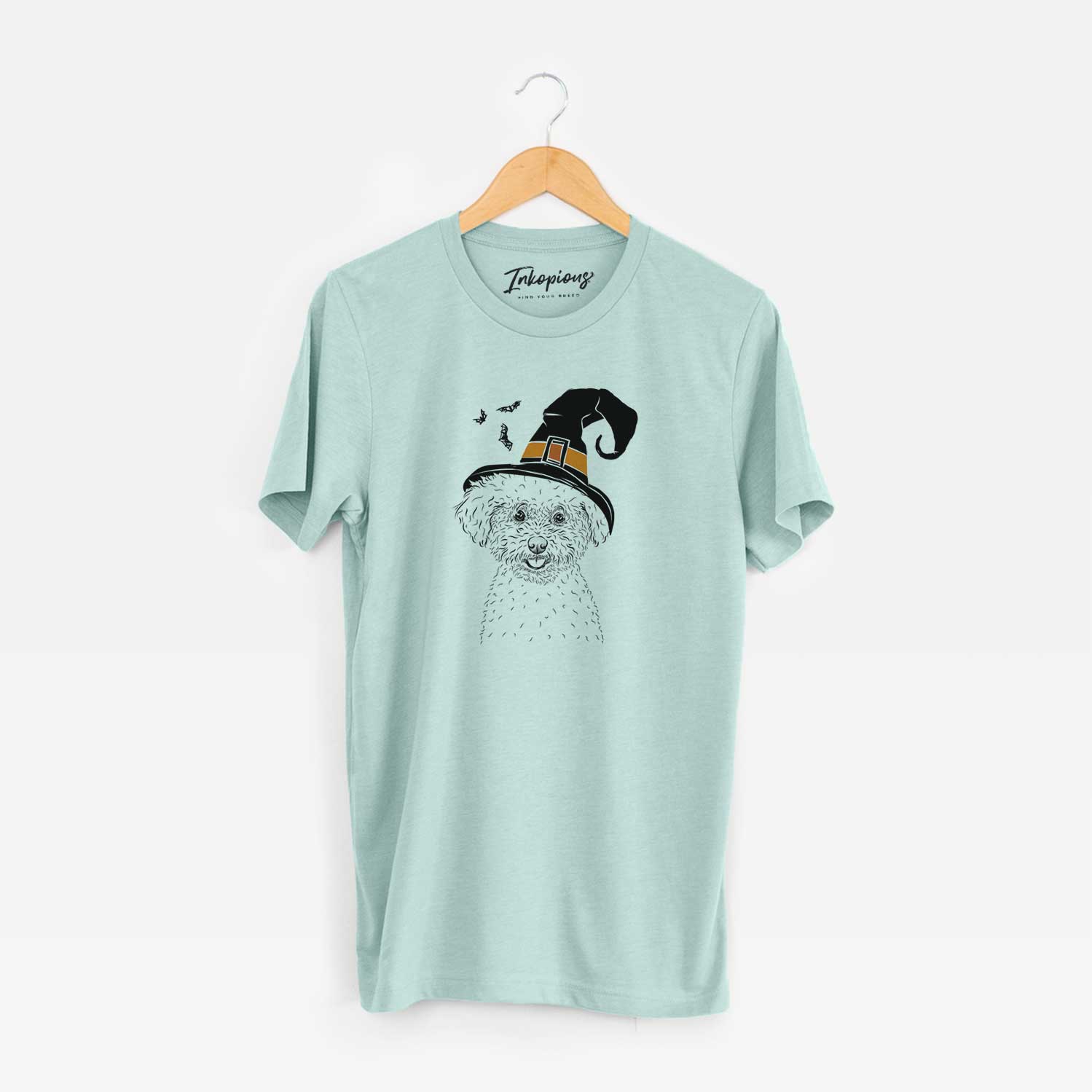 Hand-drawn sketch of Mickey the Bichon Frise wearing a witch hat on a Heather Sage Unisex crewneck
