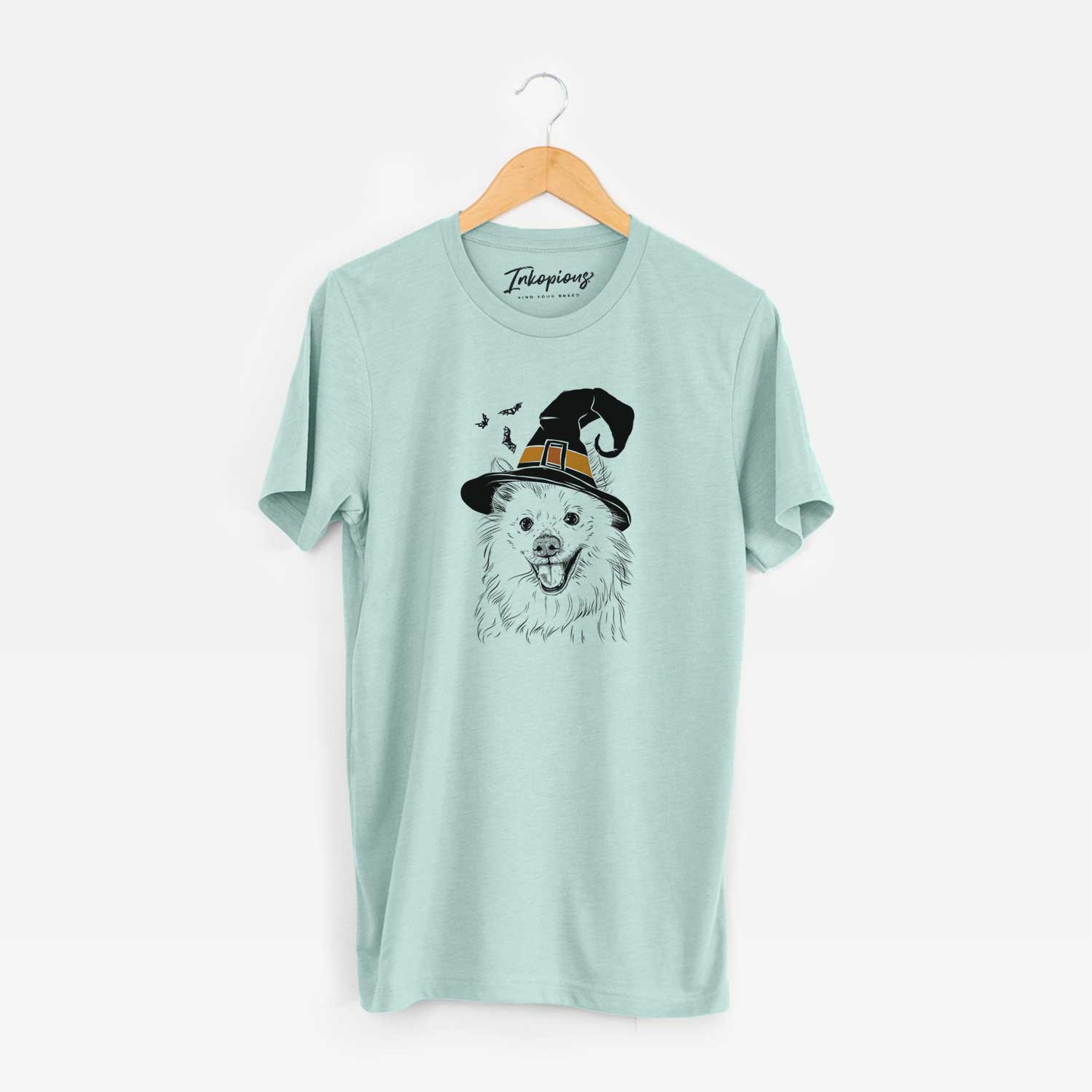 Hand-drawn sketch of Miki the American Eskimo wearing a witch hat on a Heather Sage Unisex crewneck