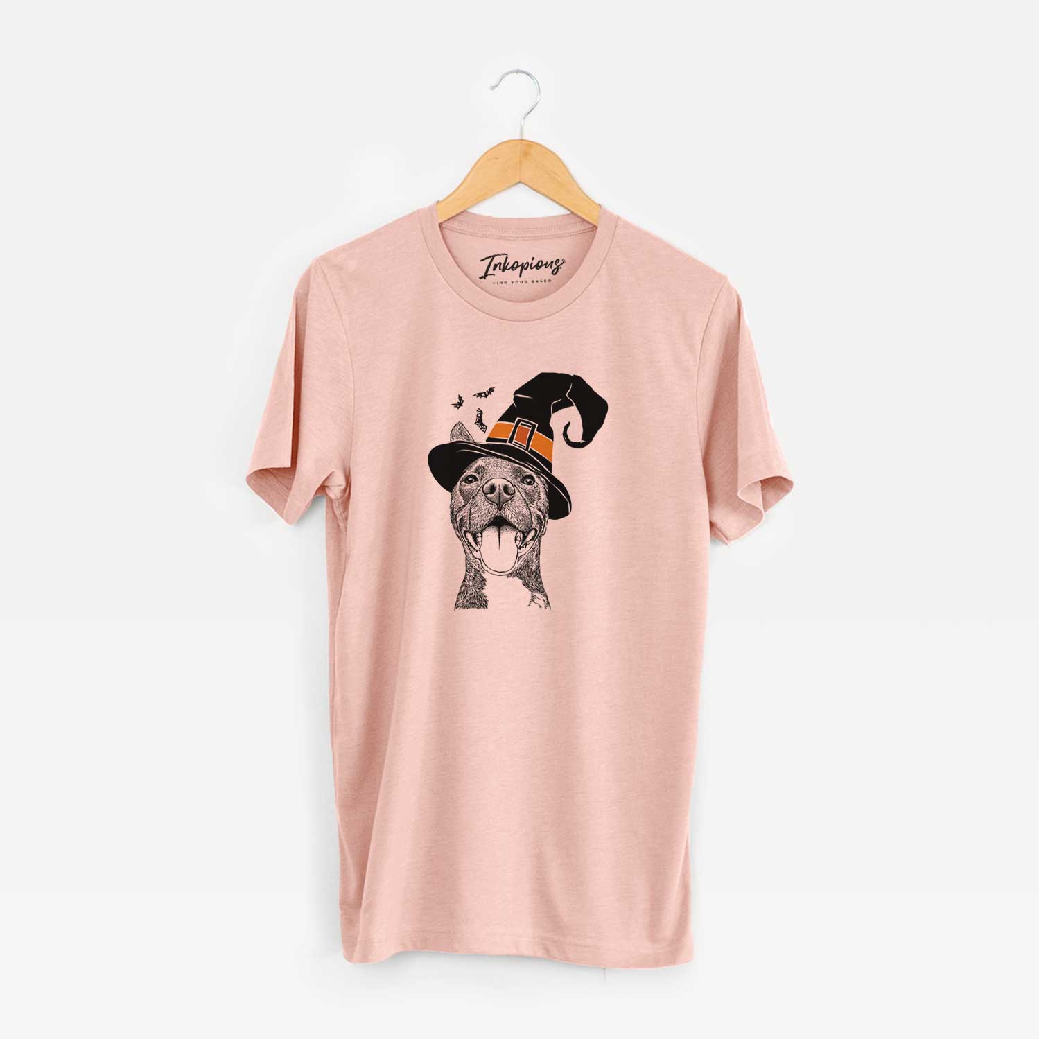 Hand-drawn sketch of Milo the Pitbull Mix wearing a witch hat on a Peach Unisex crewneck