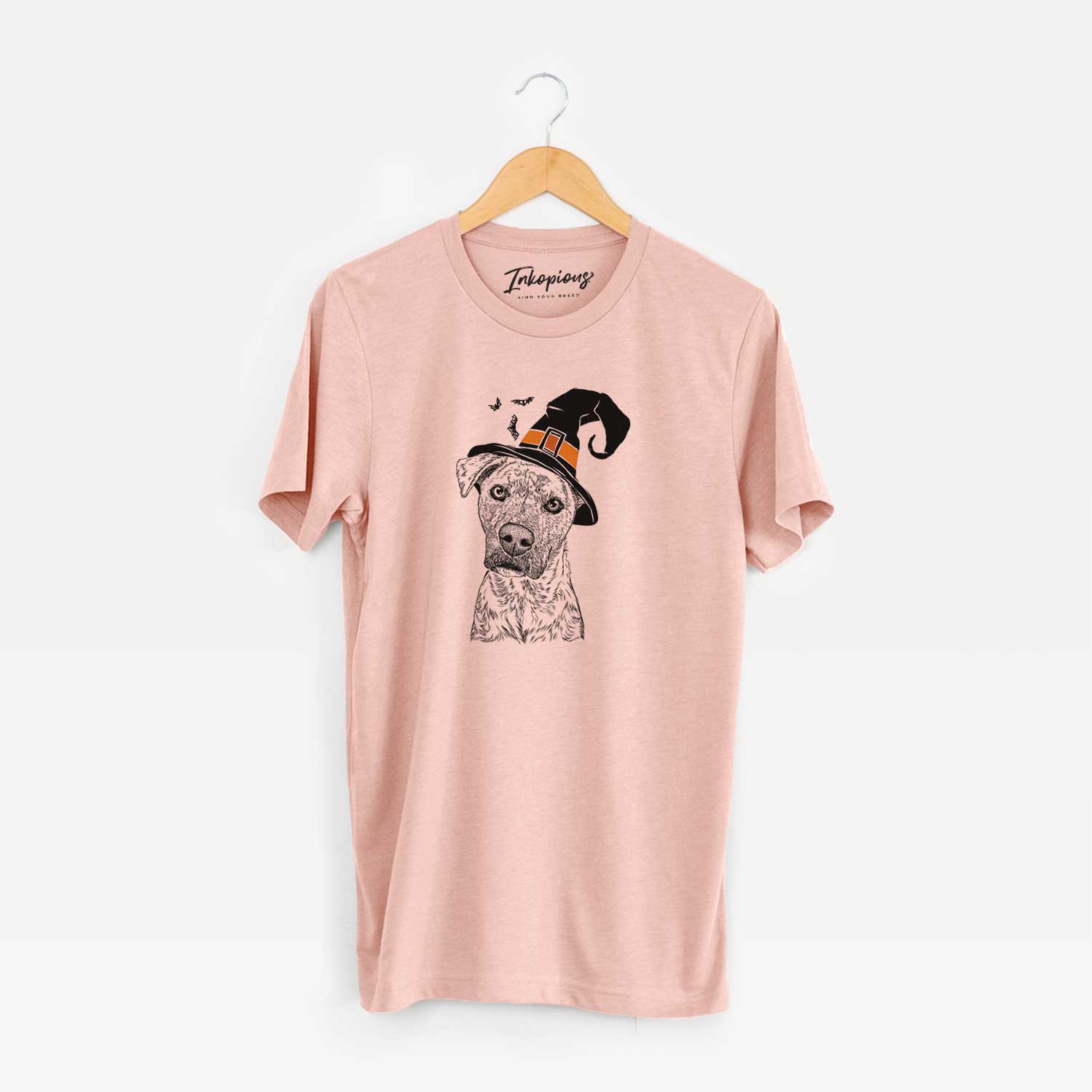 Hand-drawn sketch of Monster Baby the Pitbull Mix wearing a witch hat on a Peach Unisex crewneck