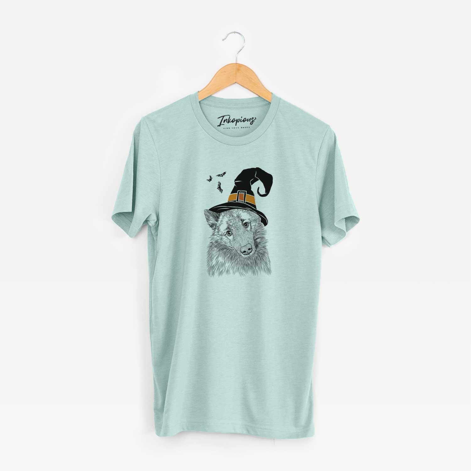 Hand-drawn sketch of Mr. Maverick the Keeshond wearing a witch hat on a Heather Sage Unisex crewneck