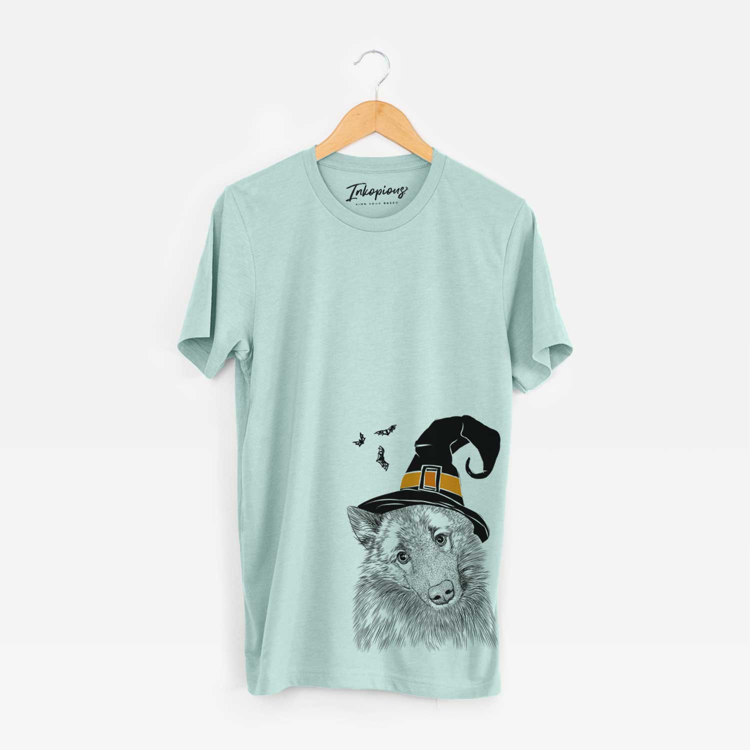 Hand-drawn sketch of Mr. Maverick the Keeshond wearing a witch hat on a Heather Sage Unisex crewneck