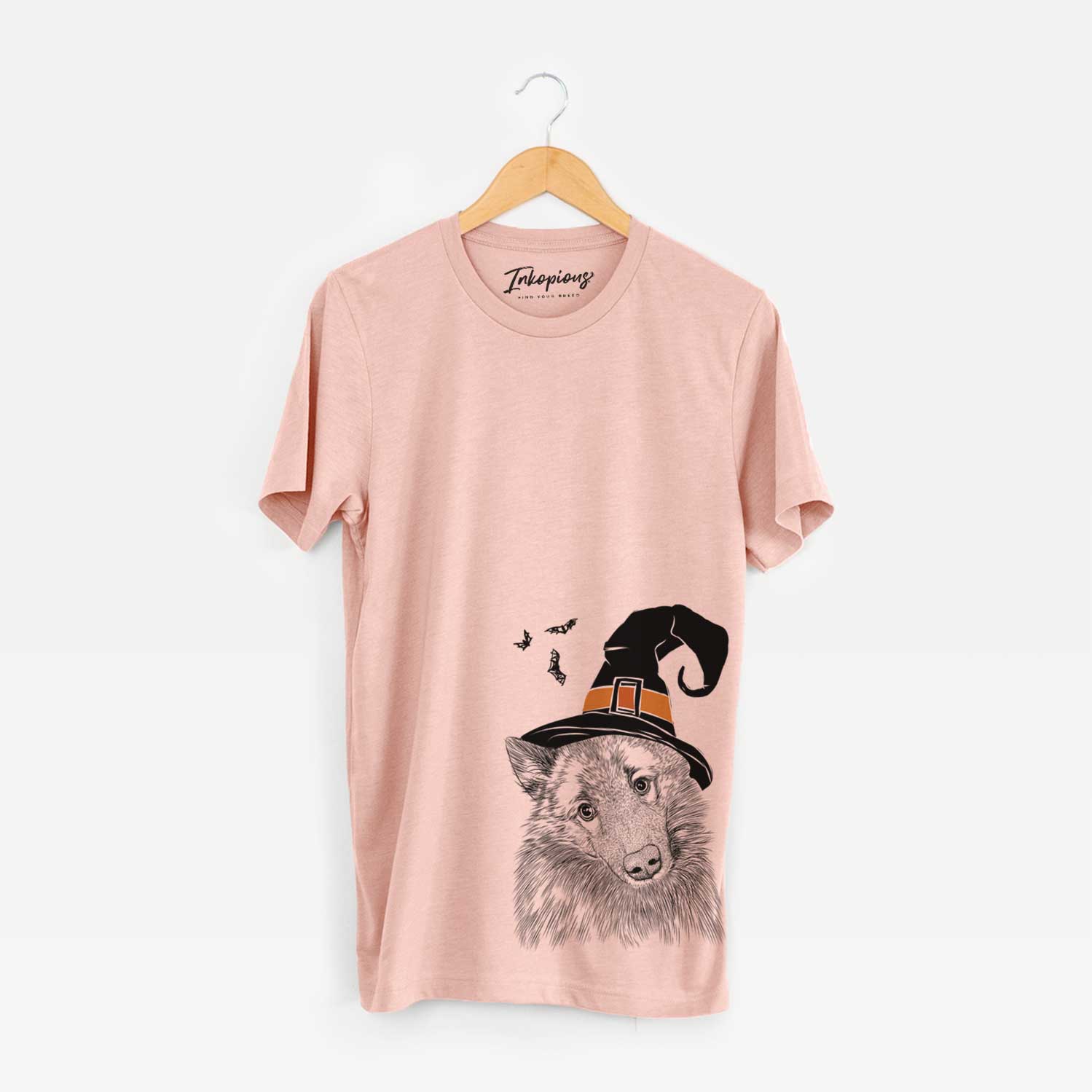 Hand-drawn sketch of Mr. Maverick the Keeshond wearing a witch hat on a Peach Unisex crewneck