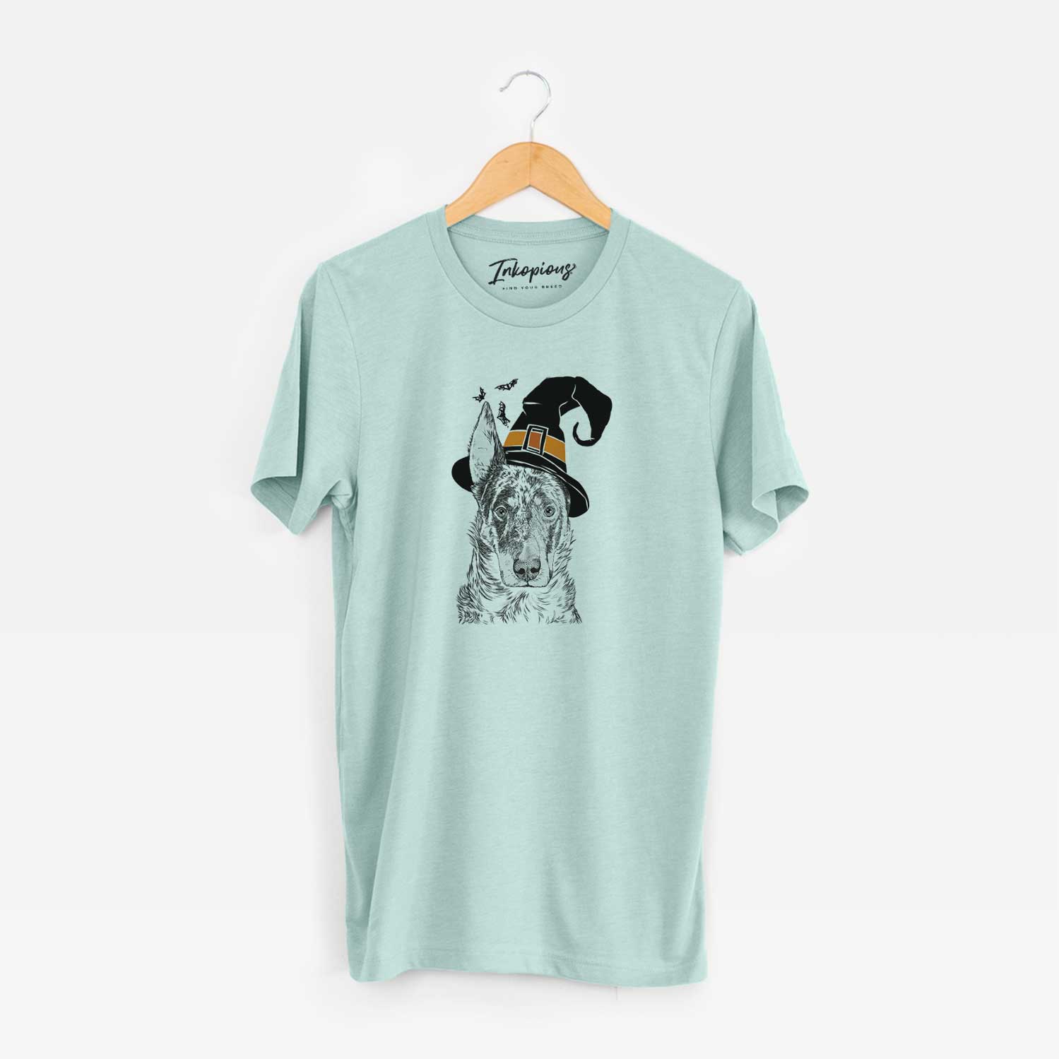 Hand-drawn sketch of Nori the Beauceron wearing a witch hat on a Heather Sage Unisex crewneck