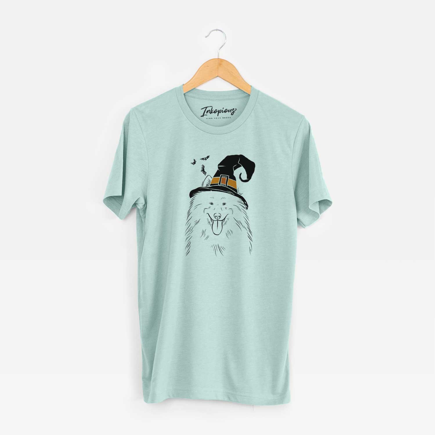 Hand-drawn sketch of Nova the Samoyed wearing a witch hat on a Heather Sage Unisex crewneck