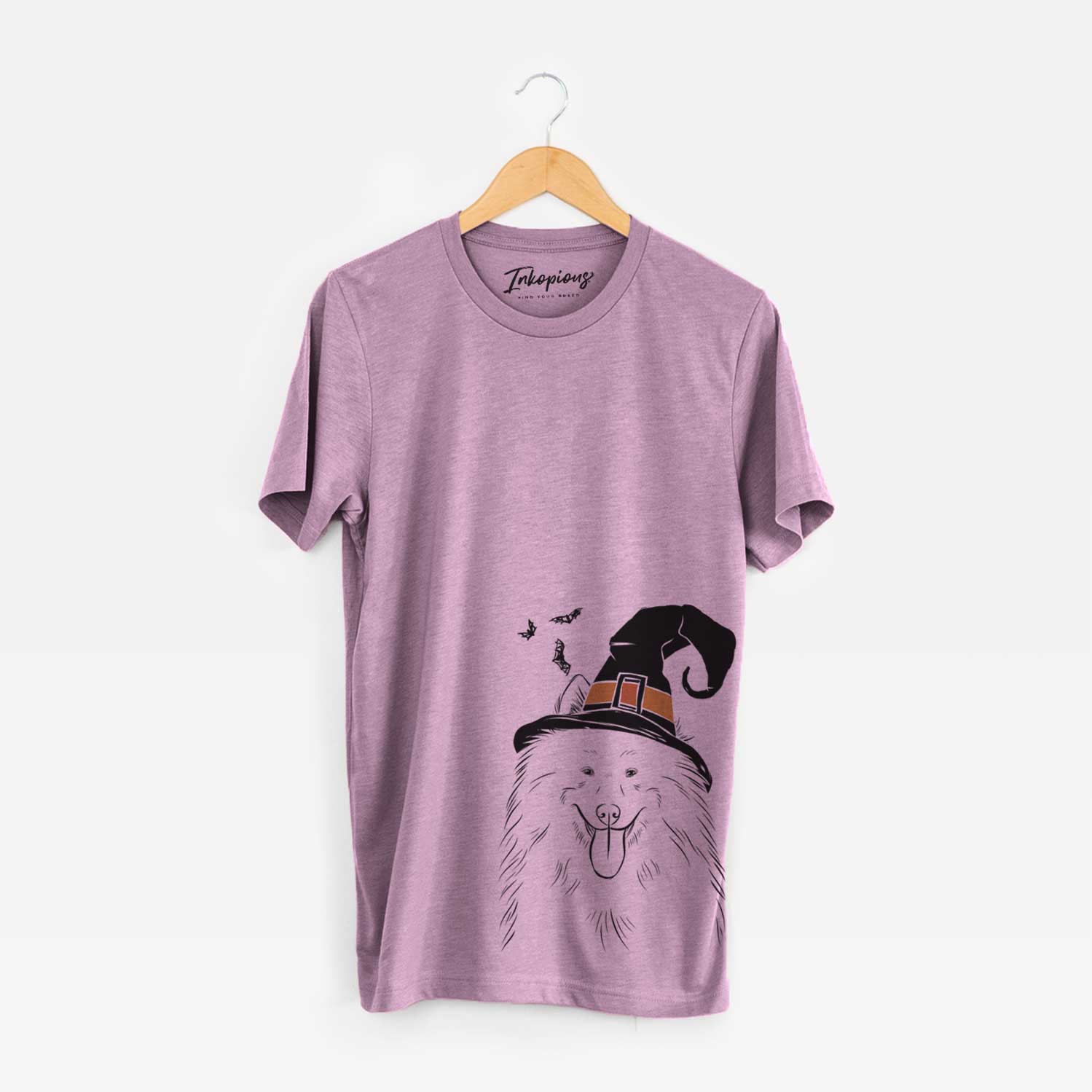 Hand-drawn sketch of Nova the Samoyed wearing a witch hat on an Orchid Unisex crewneck