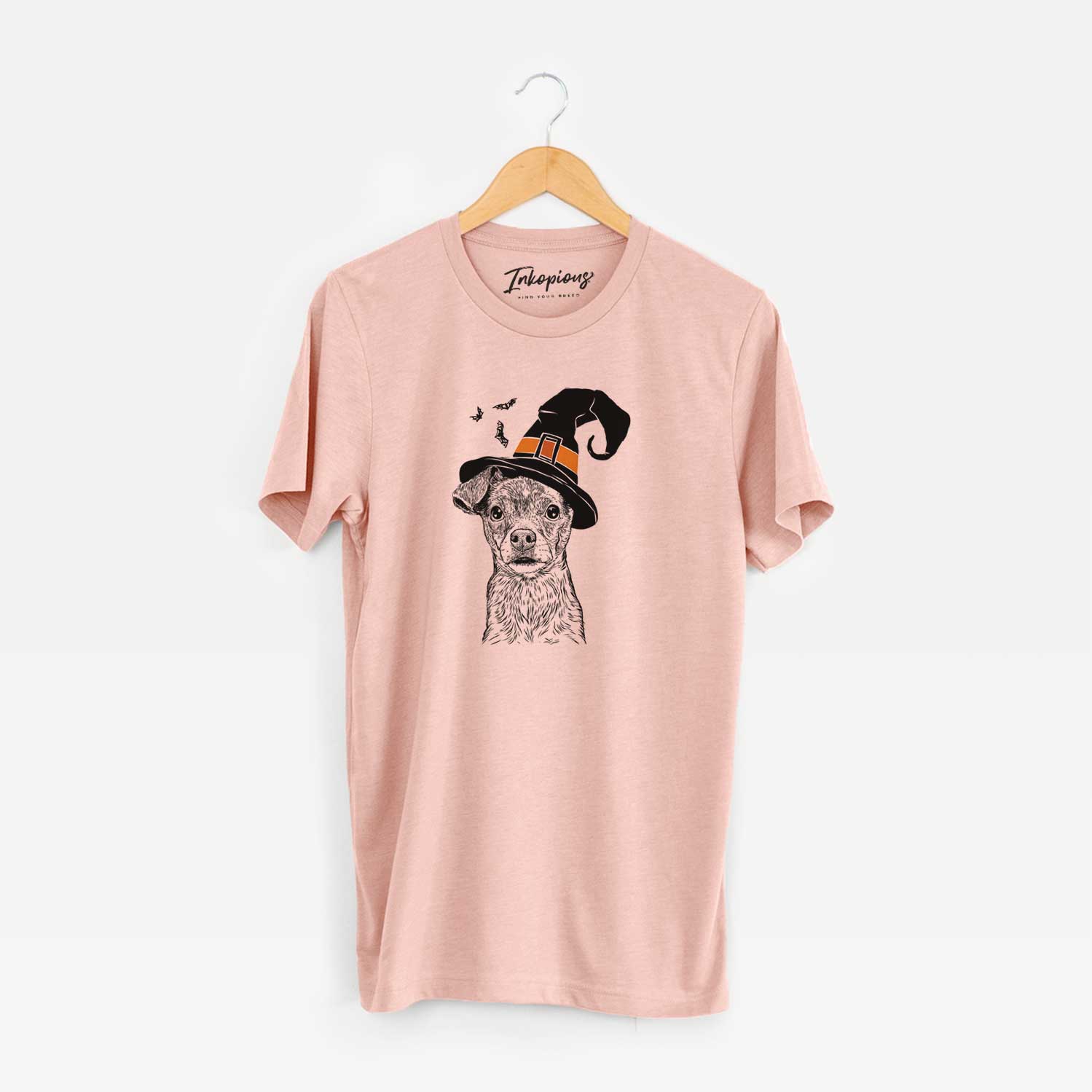 Hand-drawn sketch of Olive the Mixed Breed wearing a witch hat on a Peach Unisex crewneck