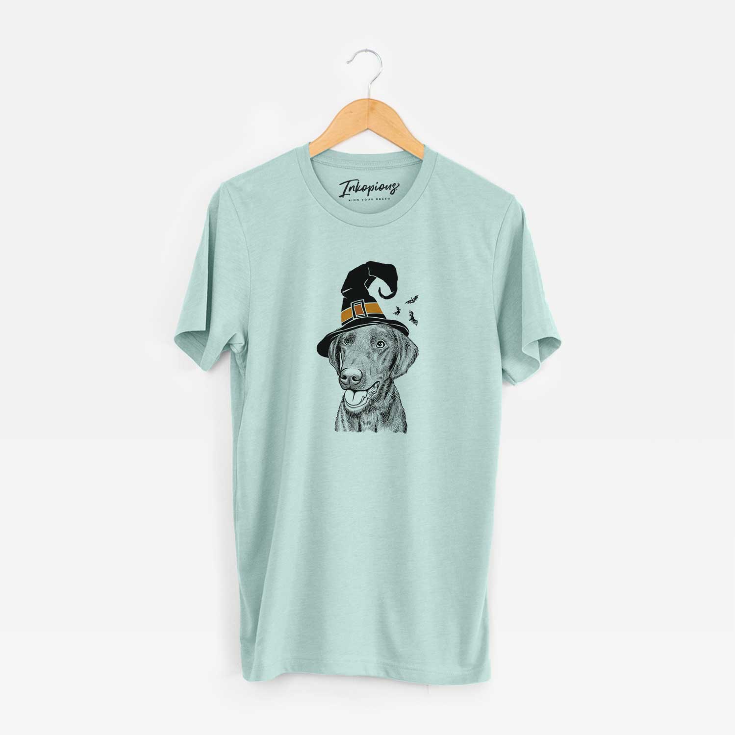 Hand-drawn sketch of Onyx the Labrador Retriever wearing a witch hat on a Heather Sage Unisex crewneck