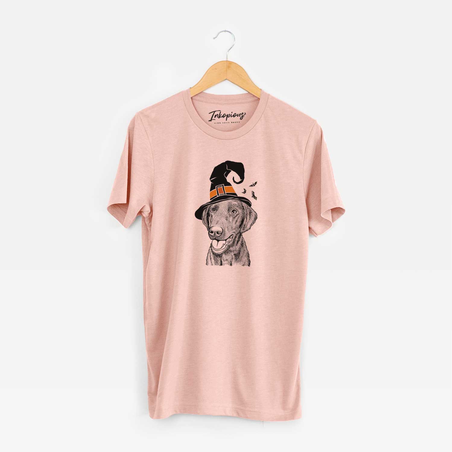 Hand-drawn sketch of Onyx the Labrador Retriever wearing a witch hat on a Peach Unisex crewneck