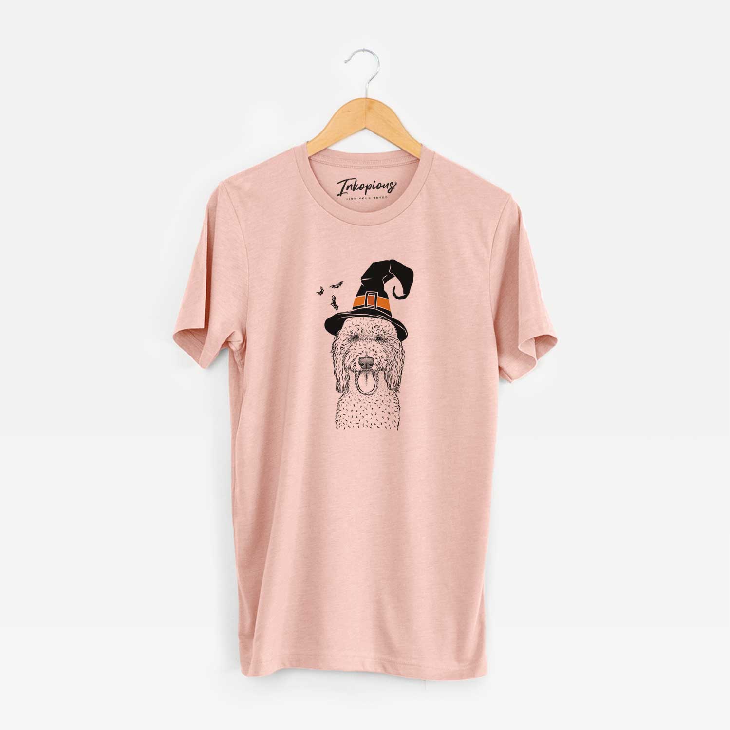Hand-drawn sketch of Pavlov the Goldendoodle wearing a witch hat on a Peach Unisex crewneck