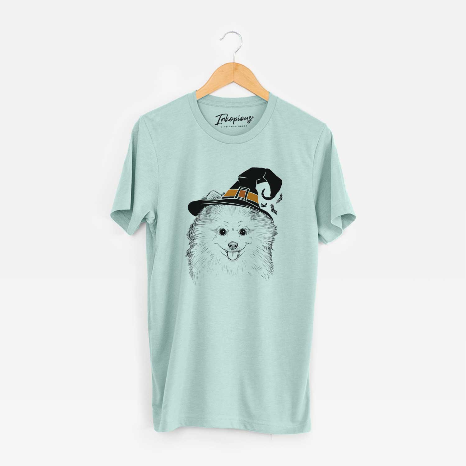 Hand-drawn sketch of Piper Jo the Pomeranian wearing a witch hat on a Heather Sage Unisex crewneck