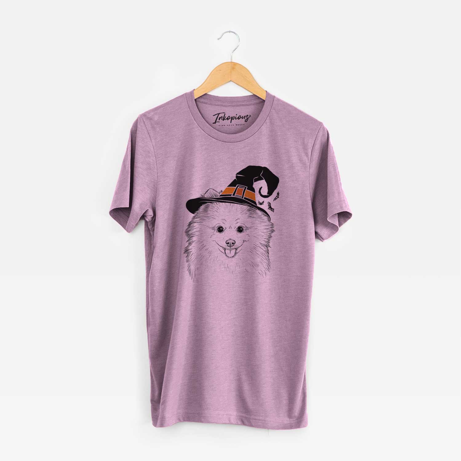 Hand-drawn sketch of Piper Jo the Pomeranian wearing a witch hat on an Orchid Unisex crewneck