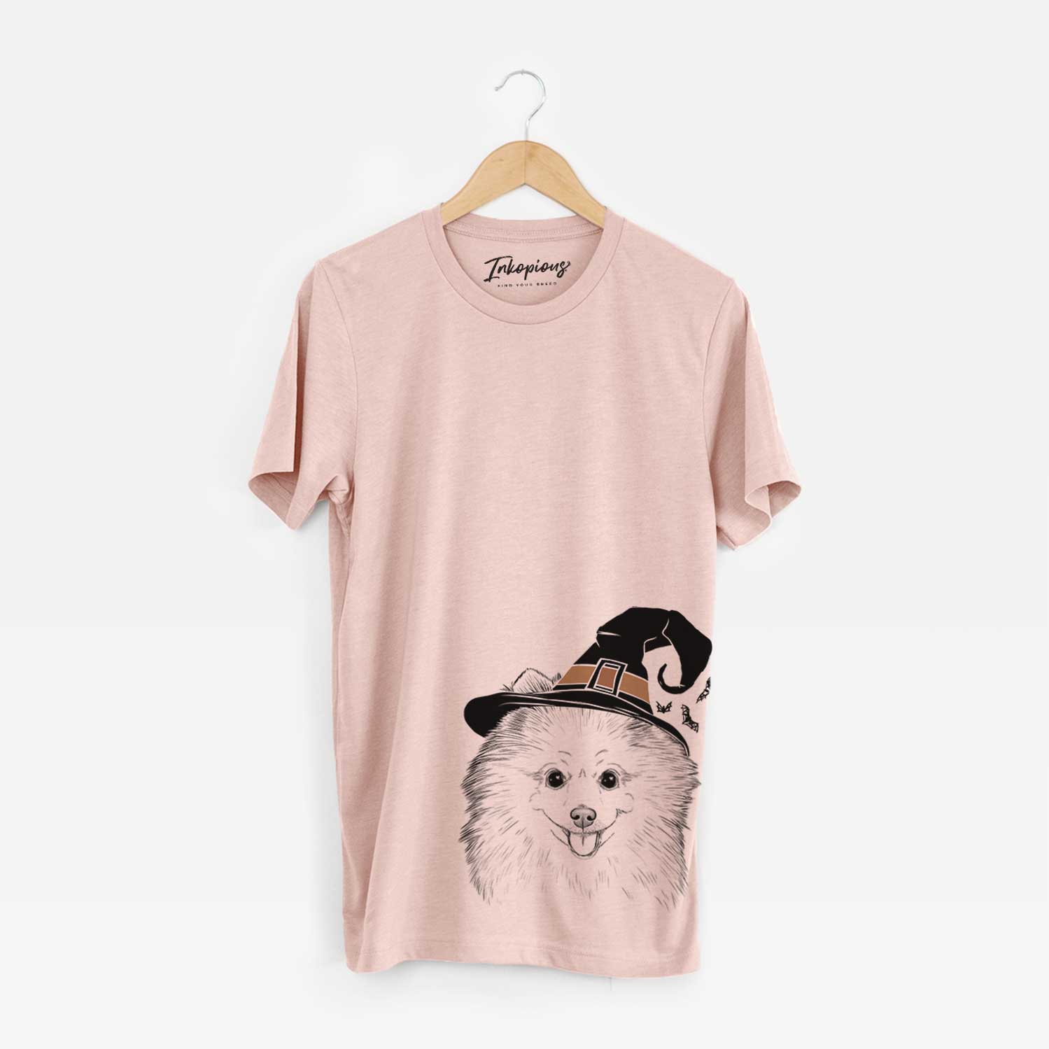 Hand-drawn sketch of Piper Jo the Pomeranian wearing a witch hat on a Peach Unisex crewneck