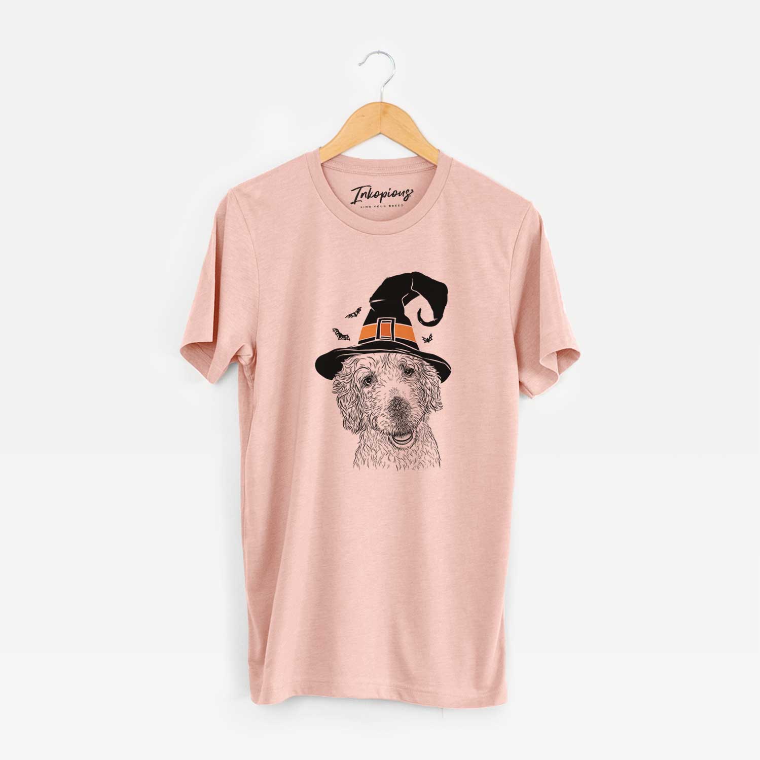 Hand-drawn sketch of Preston the Labradoodle wearing a witch hat on a Peach Unisex crewneck