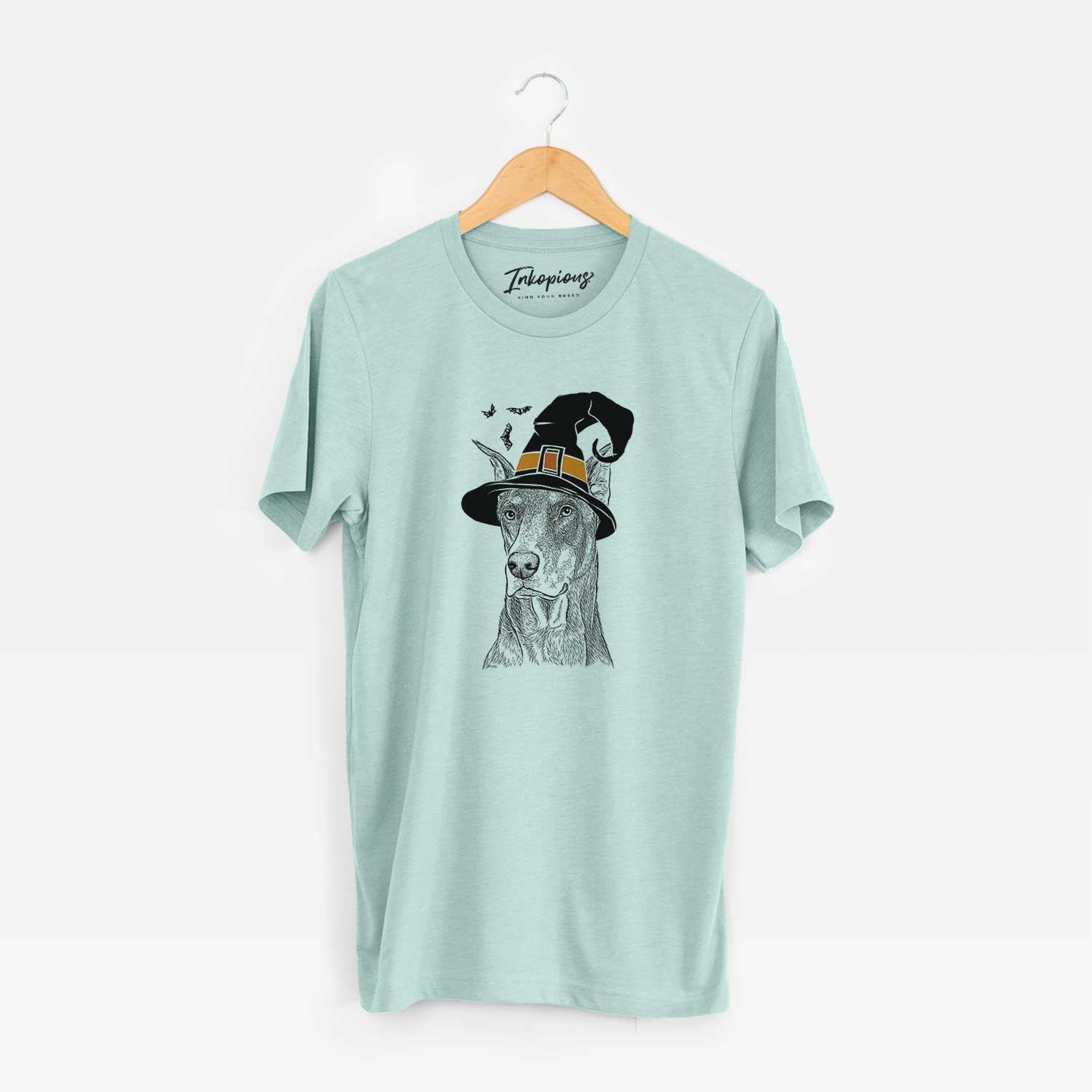 Hand-drawn sketch of RJ the Doberman Pinscher wearing a witch hat on a Heather Sage Unisex crewneck