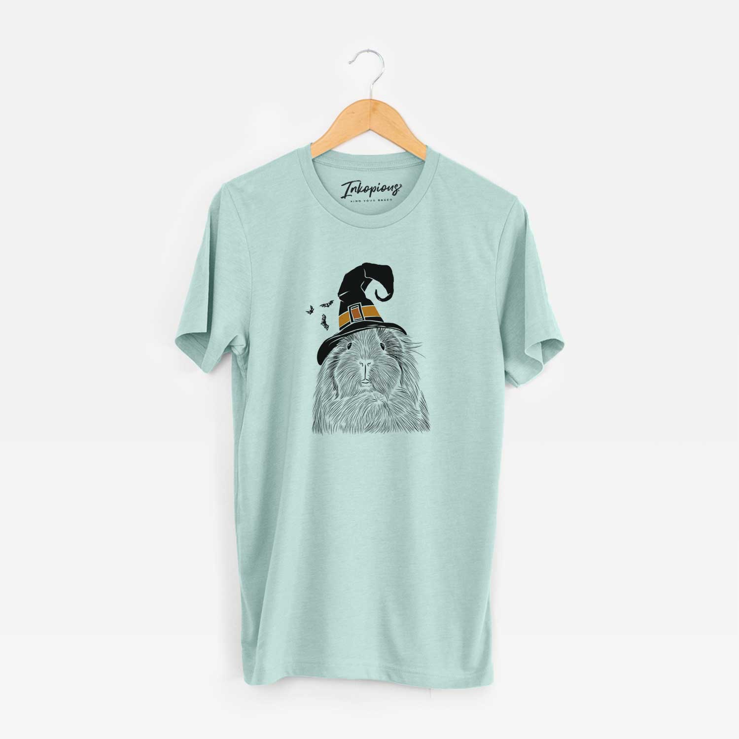 Hand-drawn sketch of Rhino the Guinea Pig wearing a witch hat on a Heather Sage Unisex crewneck