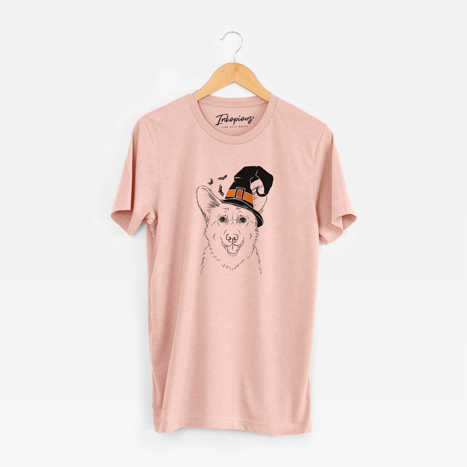 Hand-drawn sketch of Ricco the Corgi wearing a witch hat on a Peach Unisex crewneck