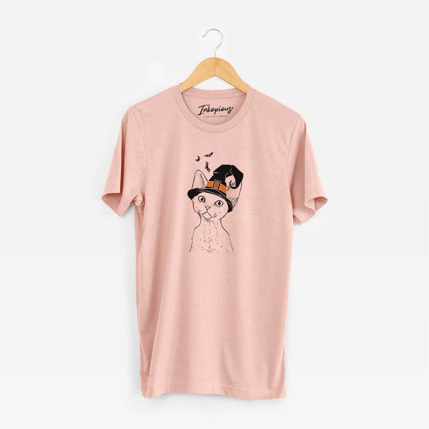 Hand-drawn sketch of Ripley the Devon Rex Cat wearing a witch hat on a Peach Unisex crewneck