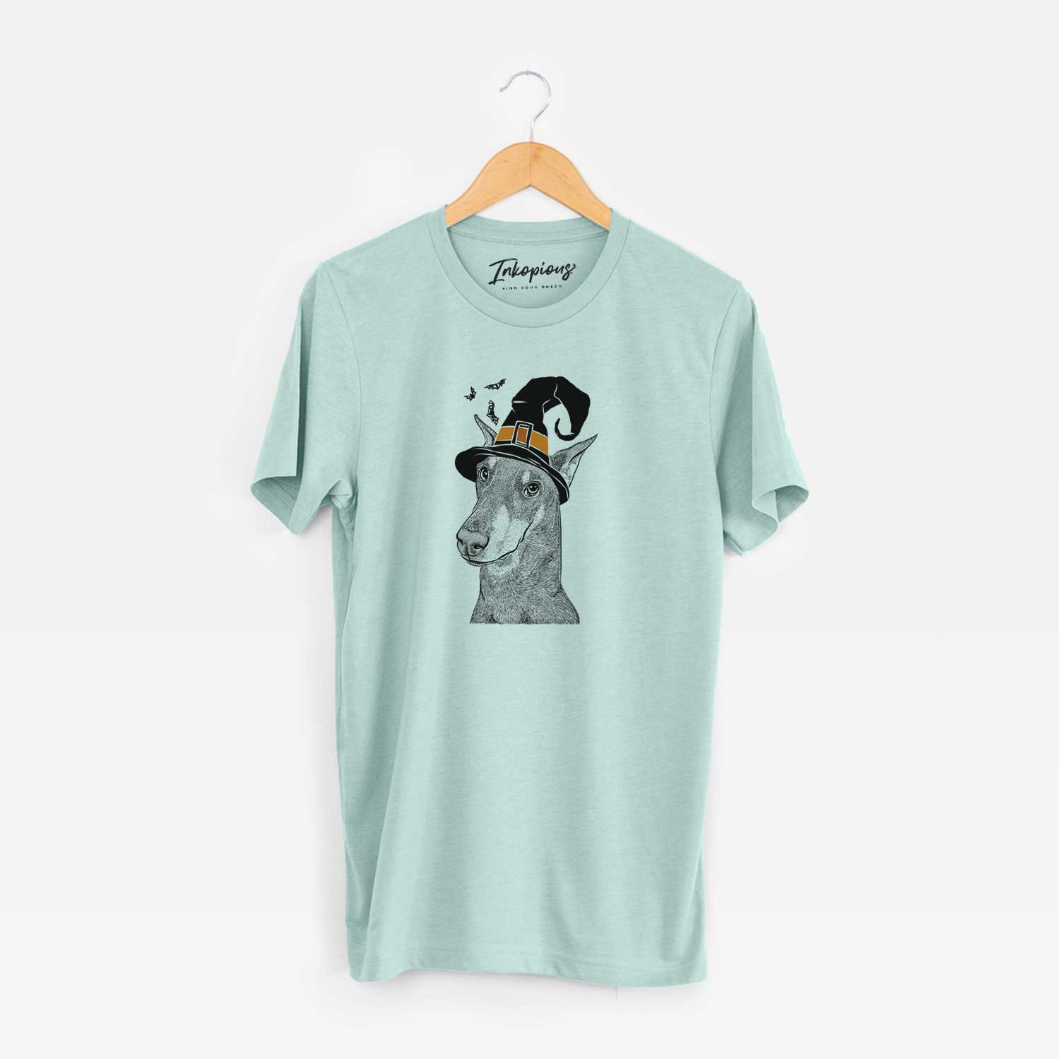 Hand-drawn sketch of Shelby the Doberman Pinscher wearing a witch hat on a Heather Sage Unisex crewneck