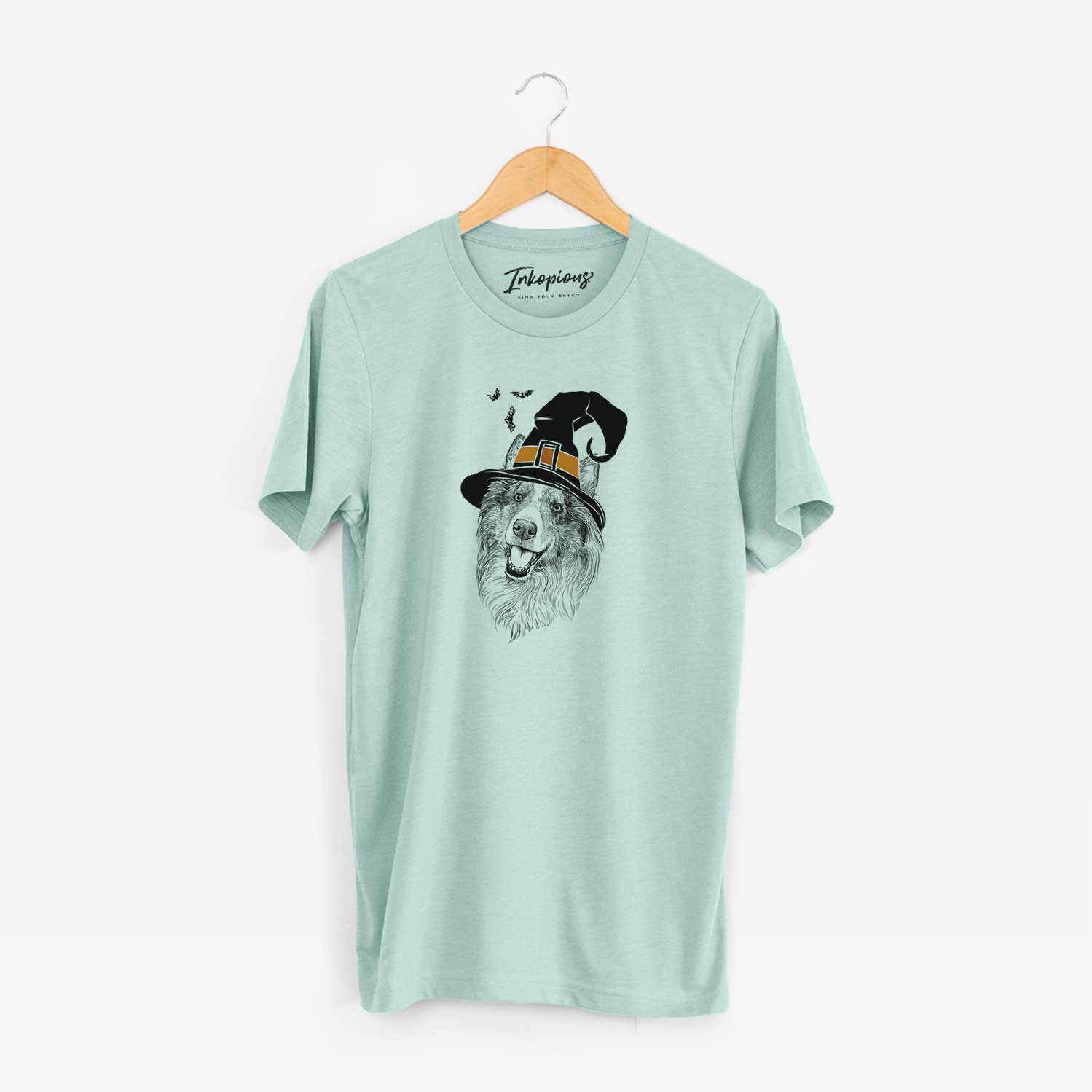 Hand-drawn sketch of Skylar the Shetland Sheepdog wearing a witch hat on a Heather Sage Unisex crewneck