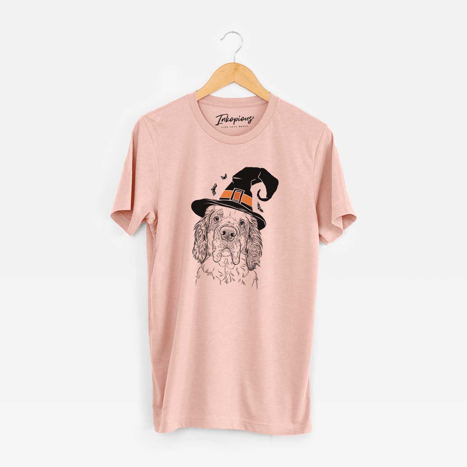 Hand-drawn sketch of Sully the Clumber Spaniel wearing a witch hat on a Peach Unisex crewneck