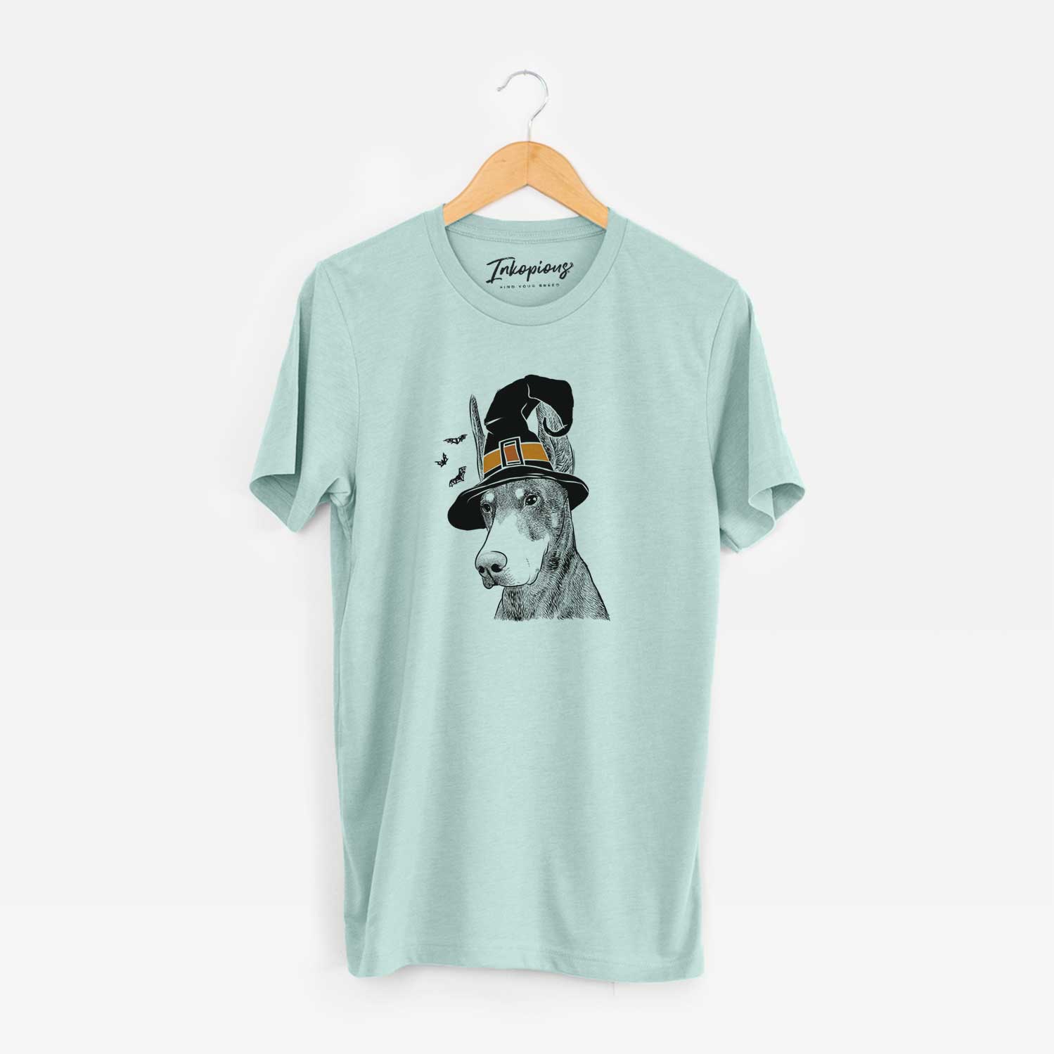 Hand-drawn sketch of Sunny the Doberman Pinscher wearing a witch hat on a Heather Sage Unisex crewneck