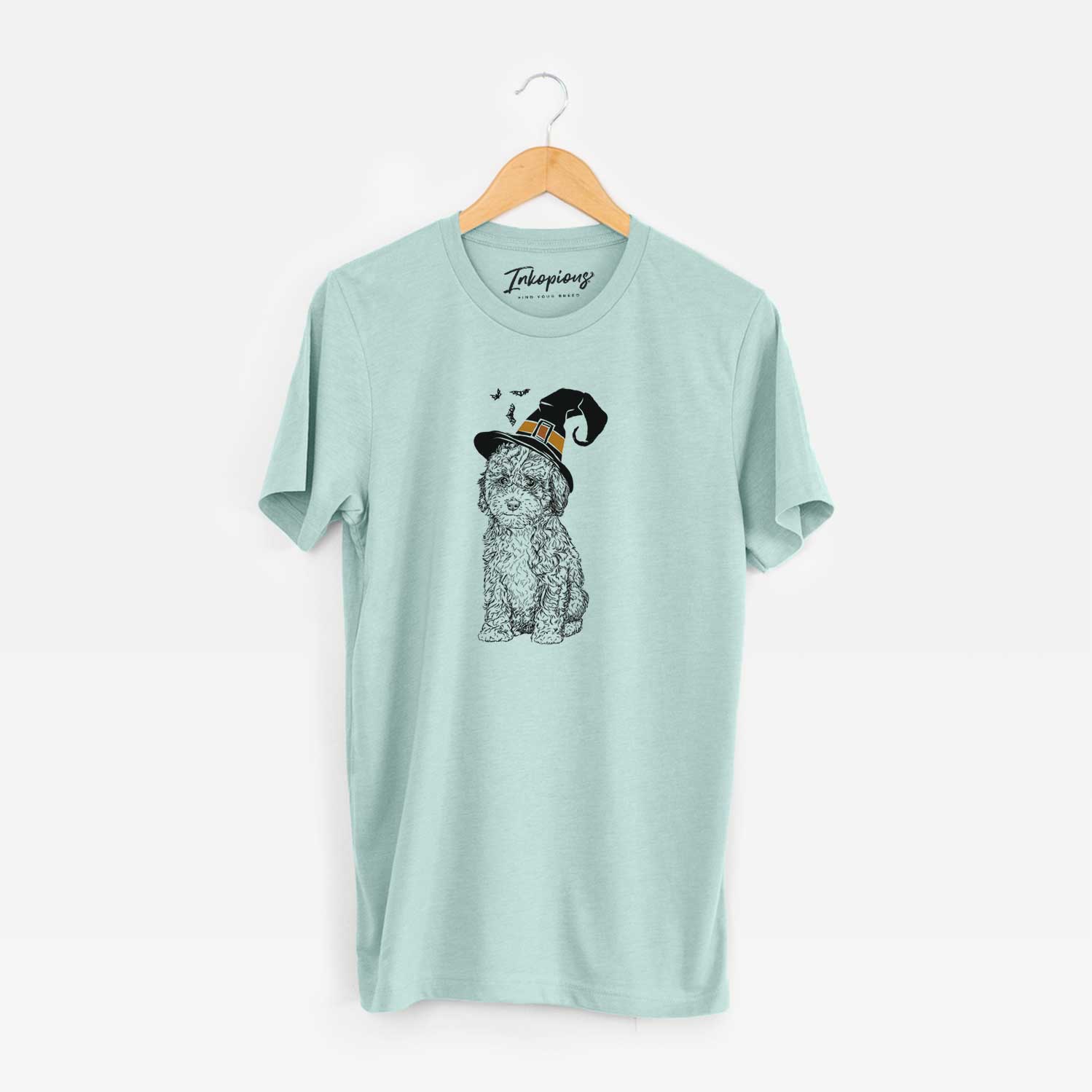 Hand-drawn sketch of Sweet Tea the Mini Doodle wearing a witch hat on a Heather Sage Unisex crewneck
