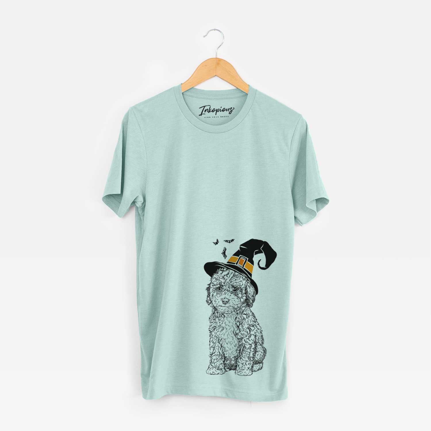 Hand-drawn sketch of Sweet Tea the Mini Doodle wearing a witch hat on a Heather Sage Unisex crewneck