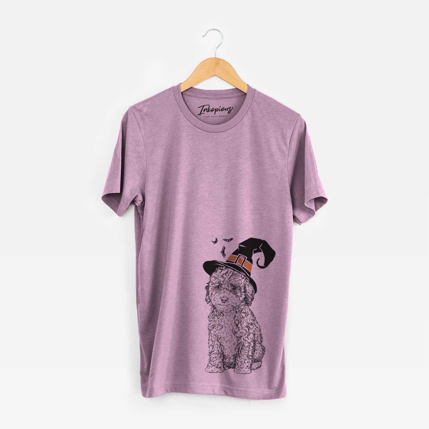 Hand-drawn sketch of Sweet Tea the Mini Doodle wearing a witch hat on an Orchid Unisex crewneck