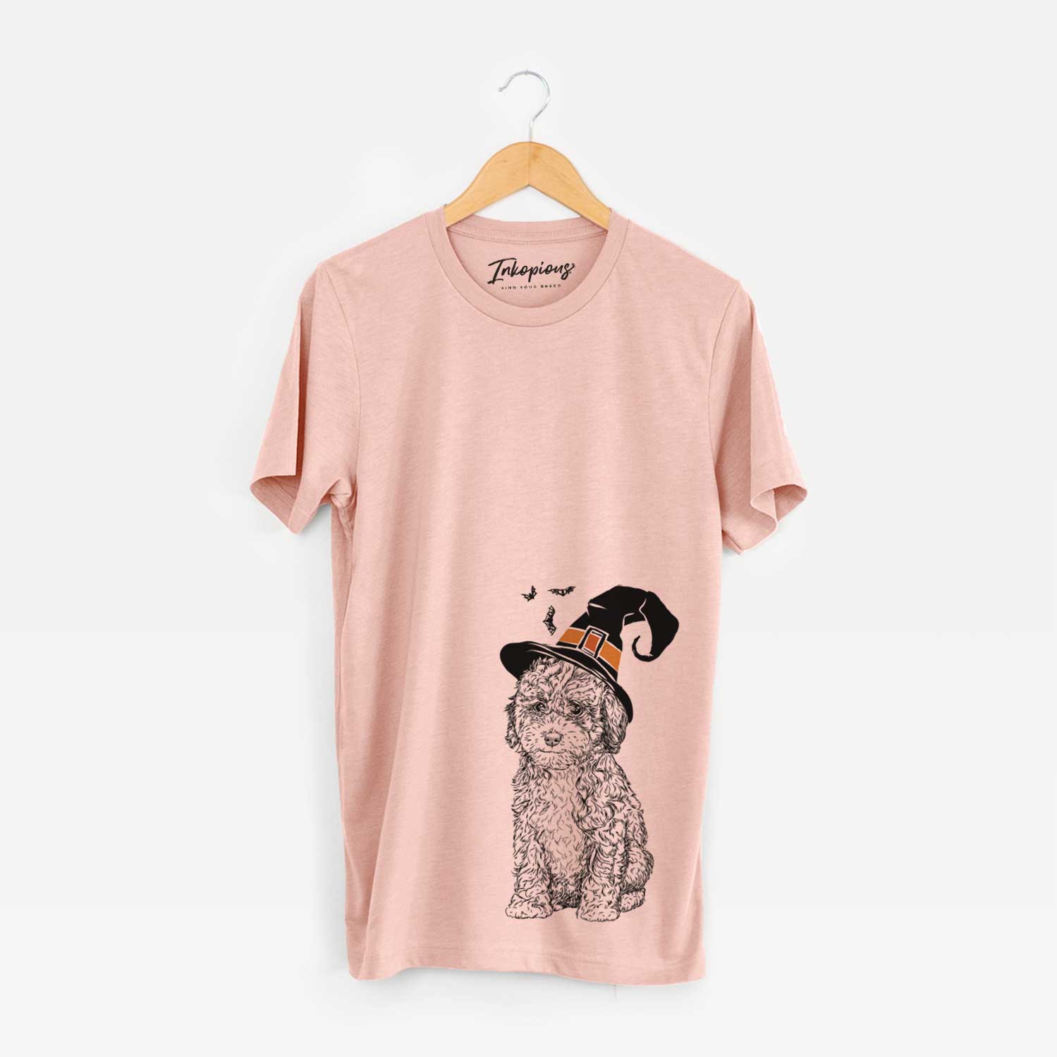 Hand-drawn sketch of Sweet Tea the Mini Doodle wearing a witch hat on a Peach Unisex crewneck
