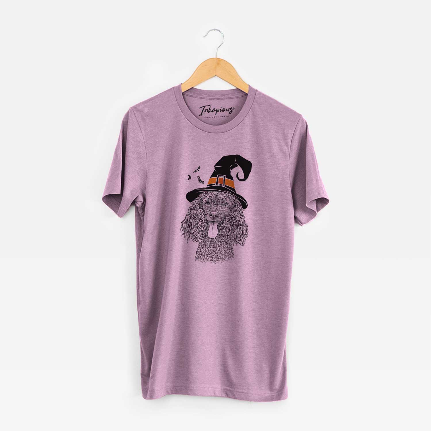 Hand-drawn sketch of Teddy the Mini Poodle wearing a witch hat on an Orchid Unisex crewneck