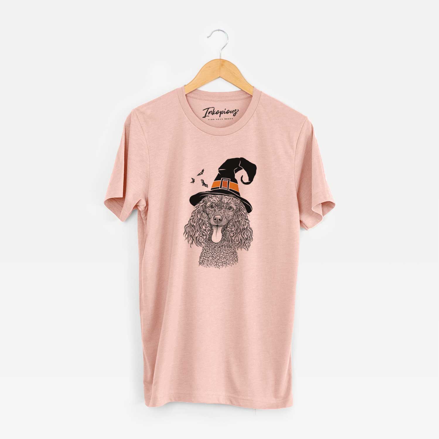 Hand-drawn sketch of Teddy the Mini Poodle wearing a witch hat on a Peach Unisex crewneck