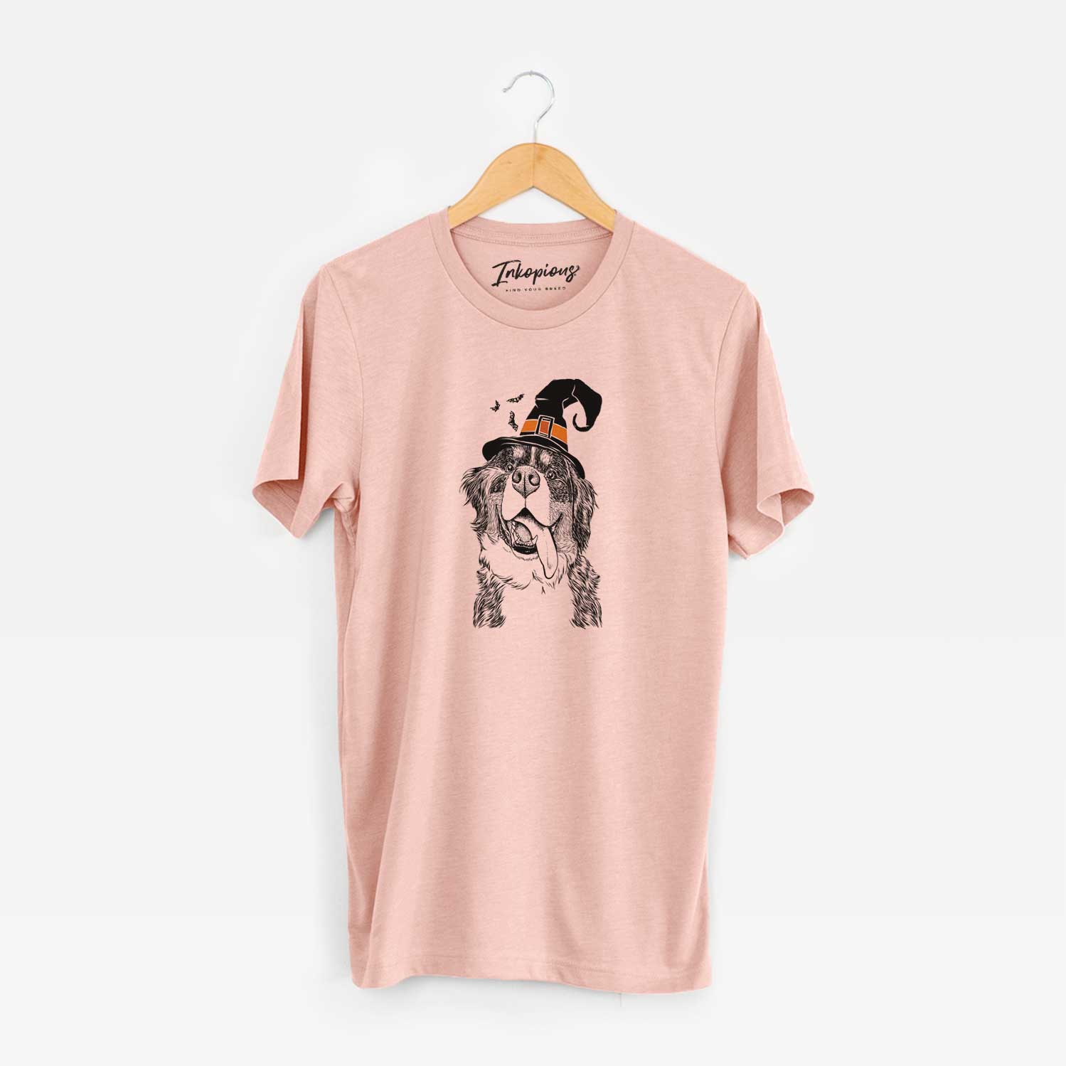 Hand-drawn sketch of Theo the Bernese Mountain Dog wearing a witch hat on a Peach Unisex crewneck