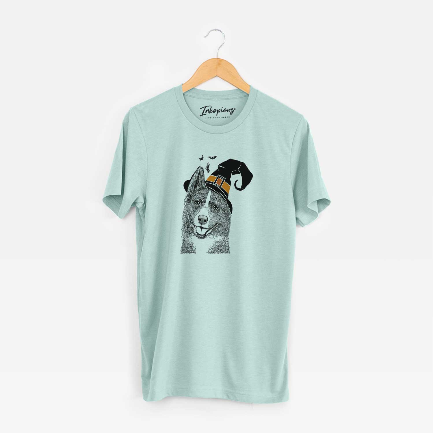 Hand-drawn sketch of Tosca the Karelian Bear Dog wearing a witch hat on a Heather Sage Unisex crewneck