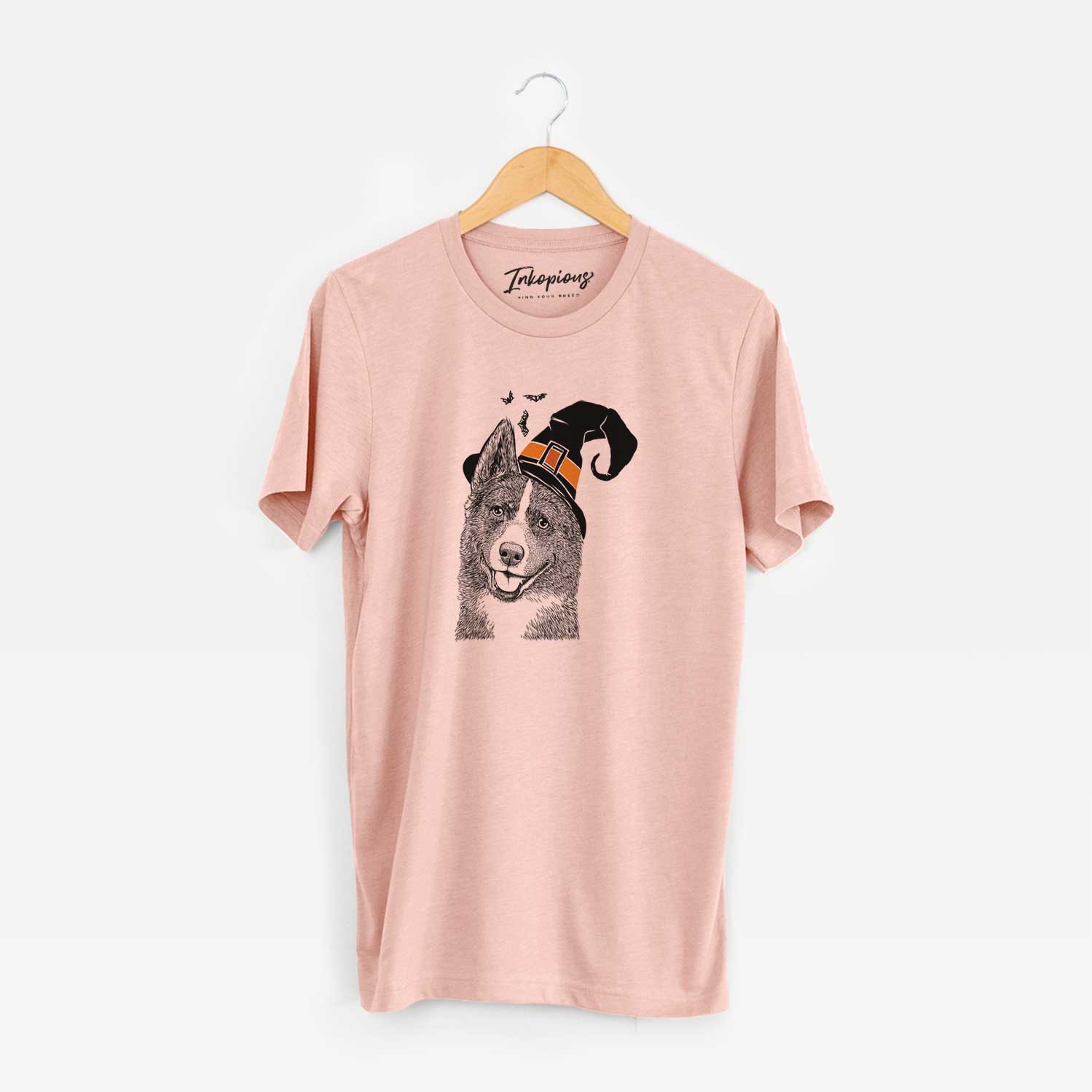 Hand-drawn sketch of Tosca the Karelian Bear Dog wearing a witch hat on a Peach Unisex crewneck