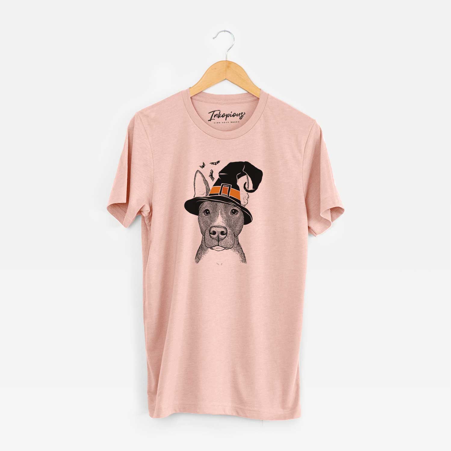 Hand-drawn sketch of Violet the Pitbull wearing a witch hat on a Peach Unisex crewneck