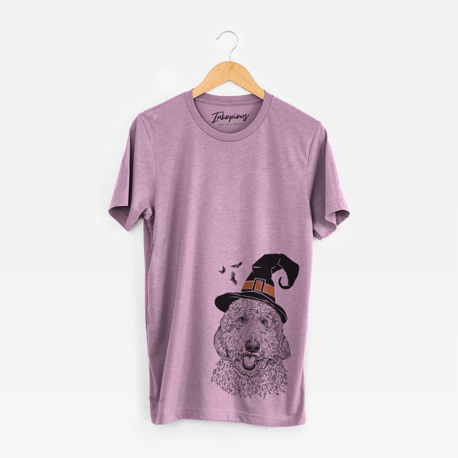 Hand-drawn sketch of Whisper the Goldendoodle wearing a witch hat on an Orchid Unisex crewneck