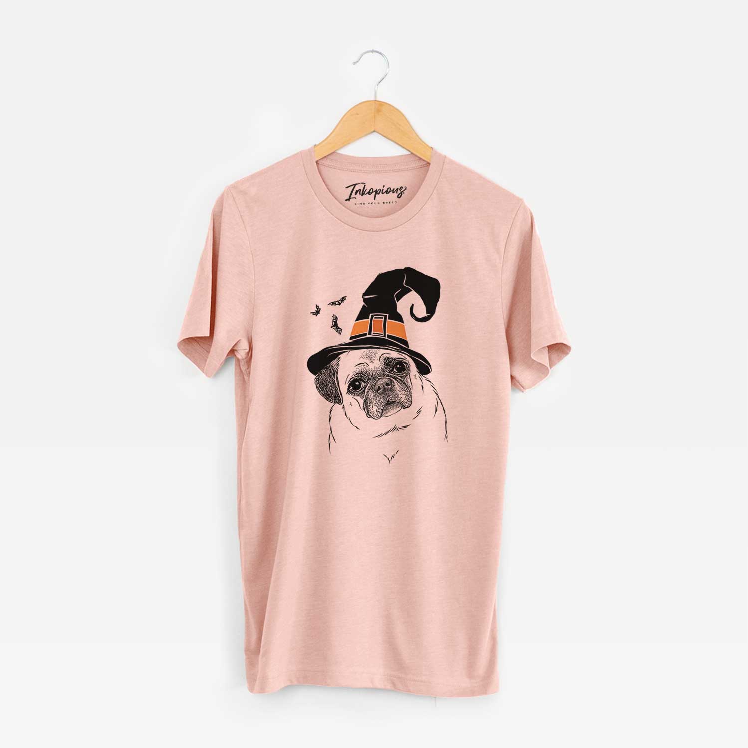 Hand-drawn sketch of Zoey the Pug wearing a witch hat on a Peach Unisex crewneck