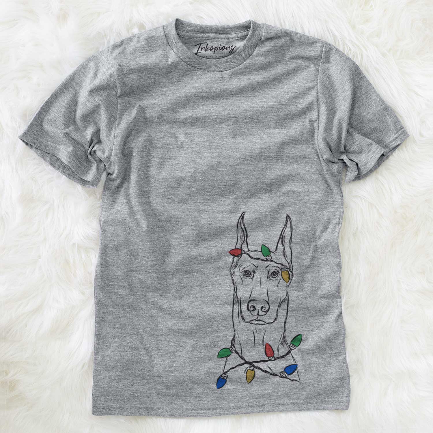 Hand-drawn sketch of Ace the Doberman Pinscher wrapped in Christmas lights on a Grey Unisex crewneck
