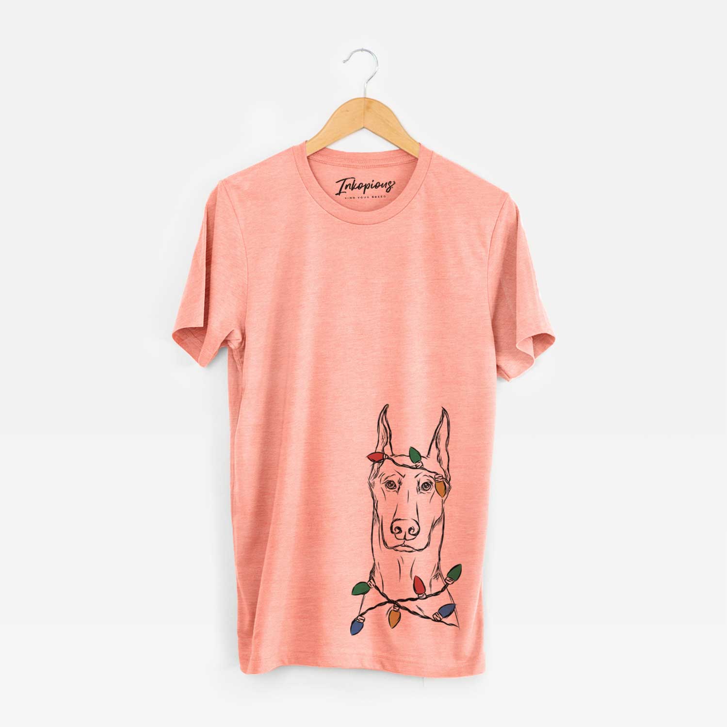 Hand-drawn sketch of Ace the Doberman Pinscher wrapped in Christmas lights on a Sunset Unisex crewneck