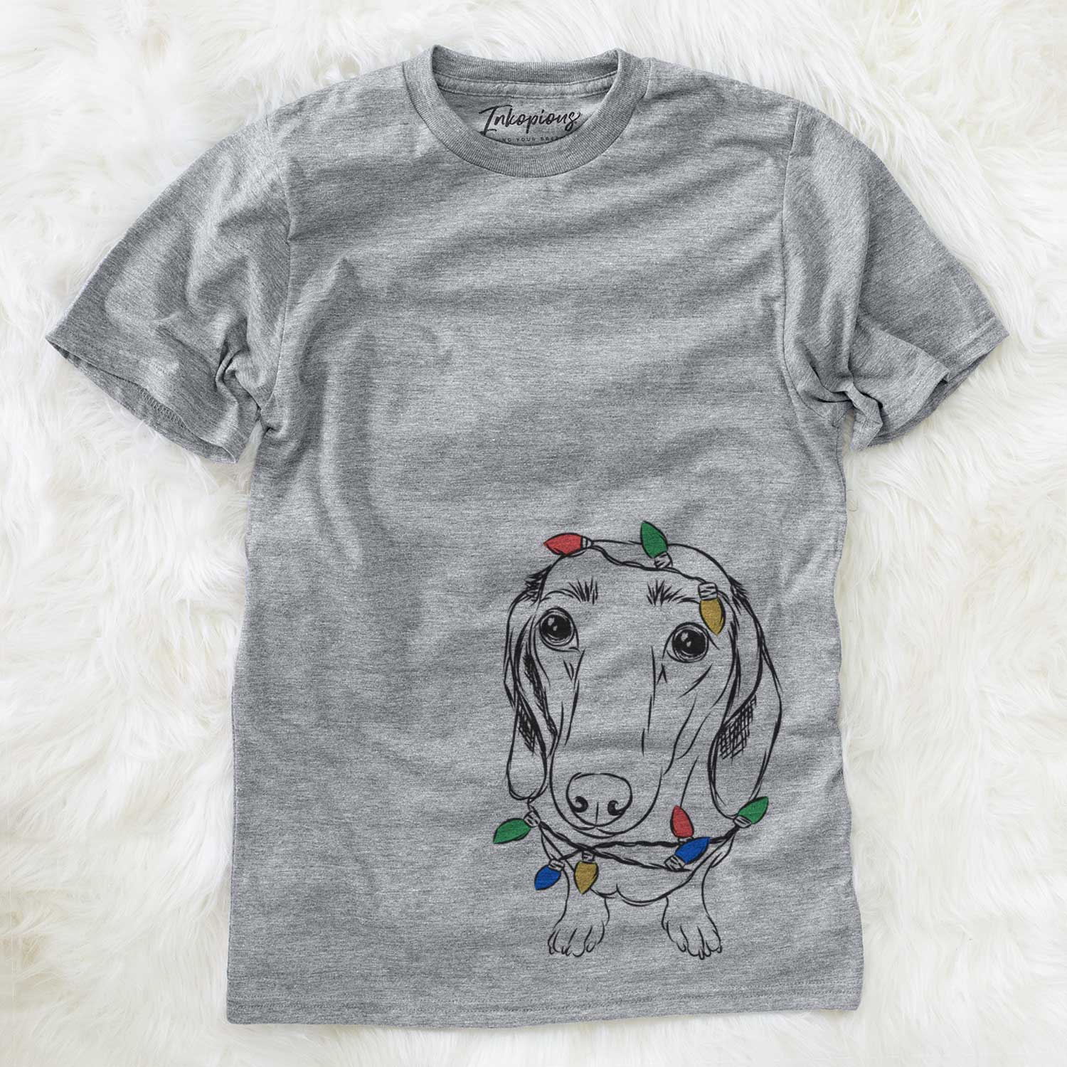 Hand-drawn sketch of Annabelle the Dachshund wrapped in Christmas lights on a Grey Unisex crewneck