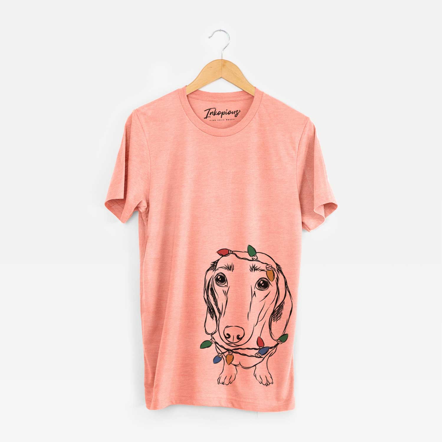 Hand-drawn sketch of Annabelle the Dachshund wrapped in Christmas lights on a Sunset Unisex crewneck