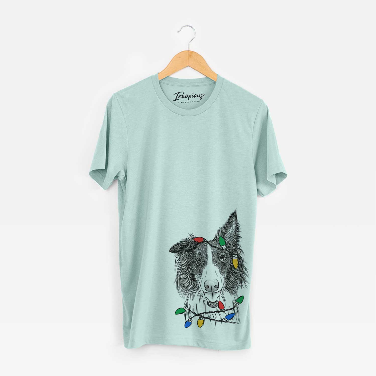 Hand-drawn sketch of Archie the Silken Windhound wrapped in Christmas lights on a Heather Sage Unisex crewneck